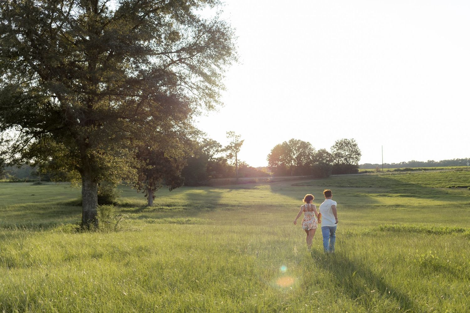 Romantic Couples photos in a tall grass field at sunset near Dothan, Alabama