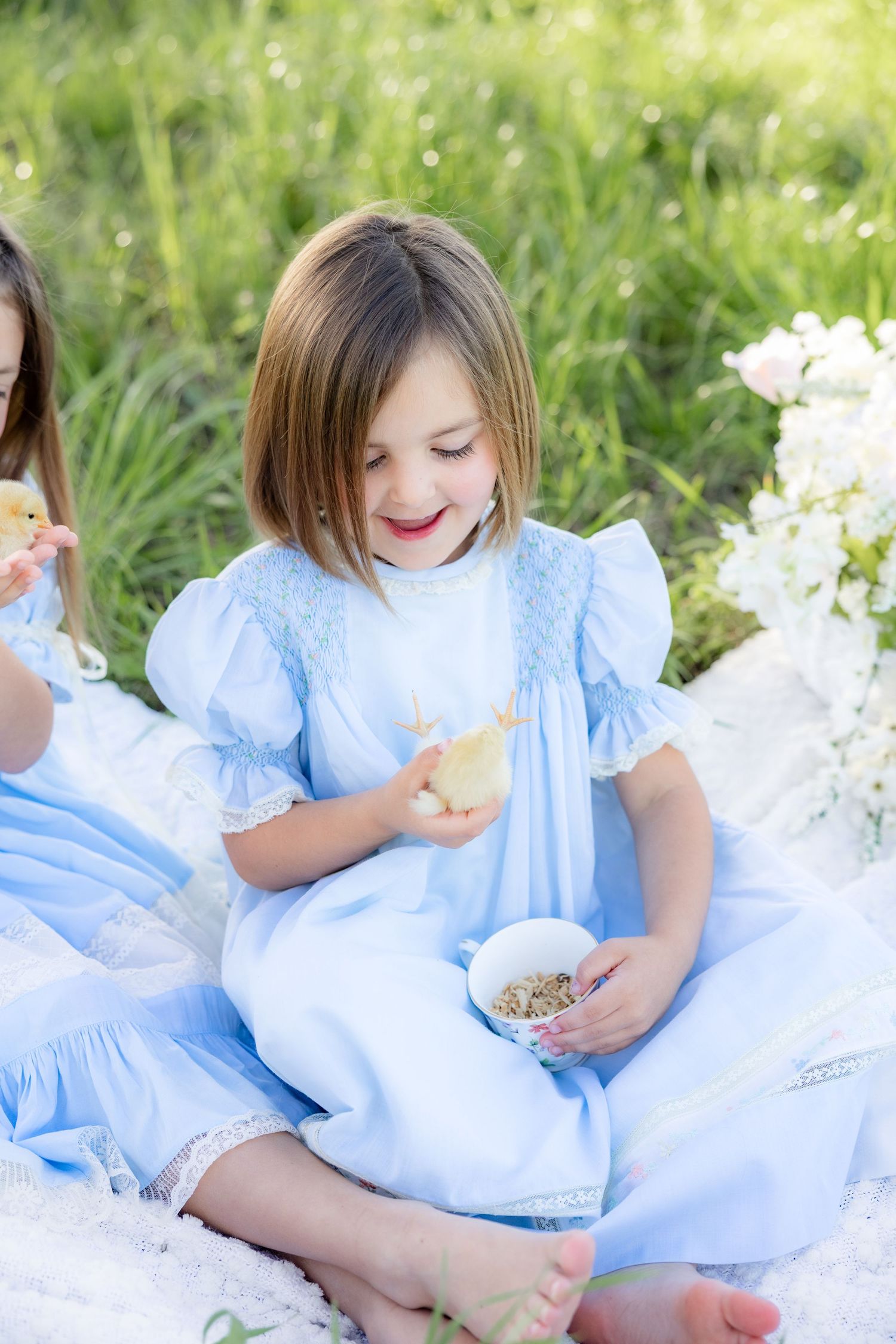 Spring Mini Session with baby chicks in a grass field at sunset near Dothan, Alabama