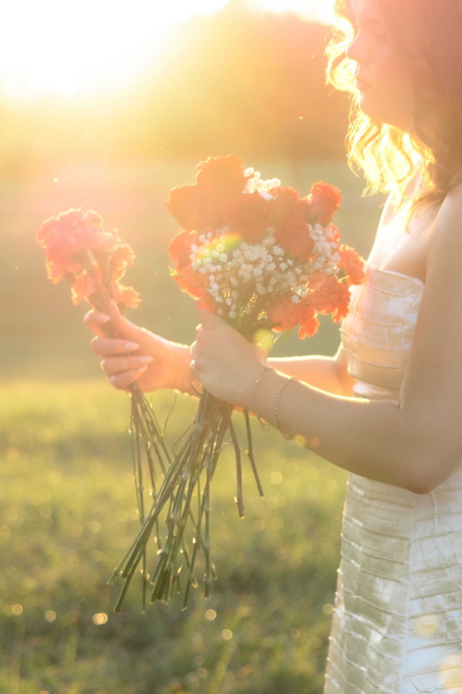 Senior pictures in a field at sunset at Troy University Dothan Campus
