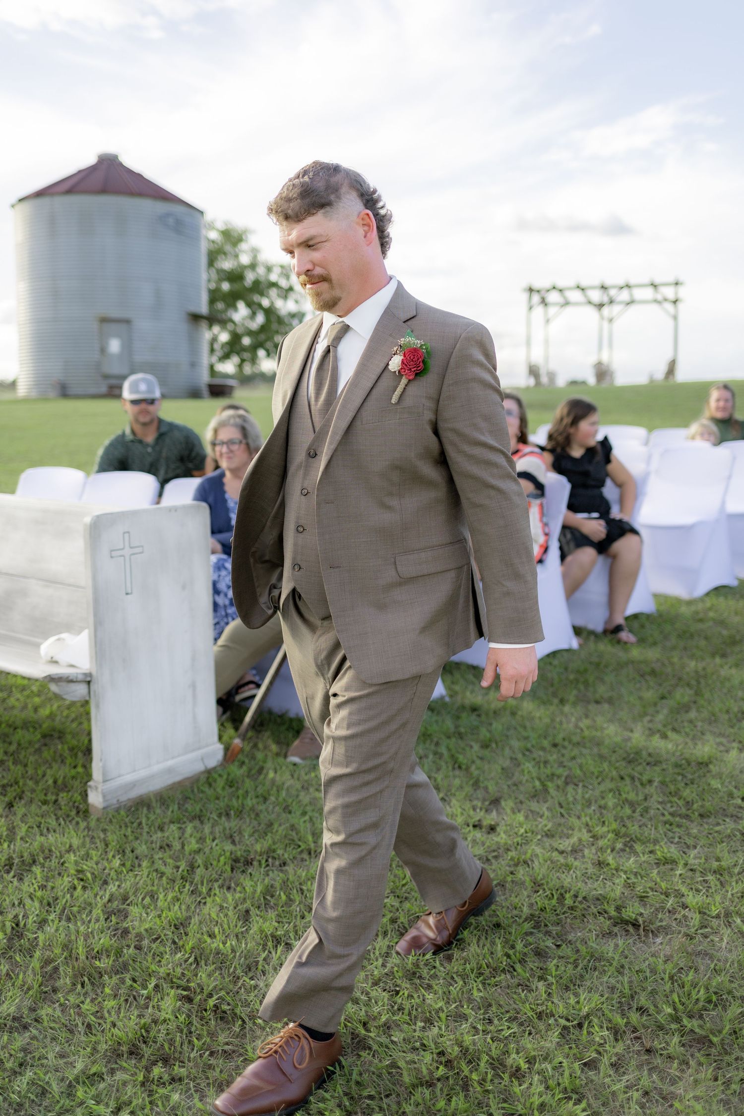 Groom walking down the aisle of a wedding at Hilltop Acres Wicksburg, Alabama