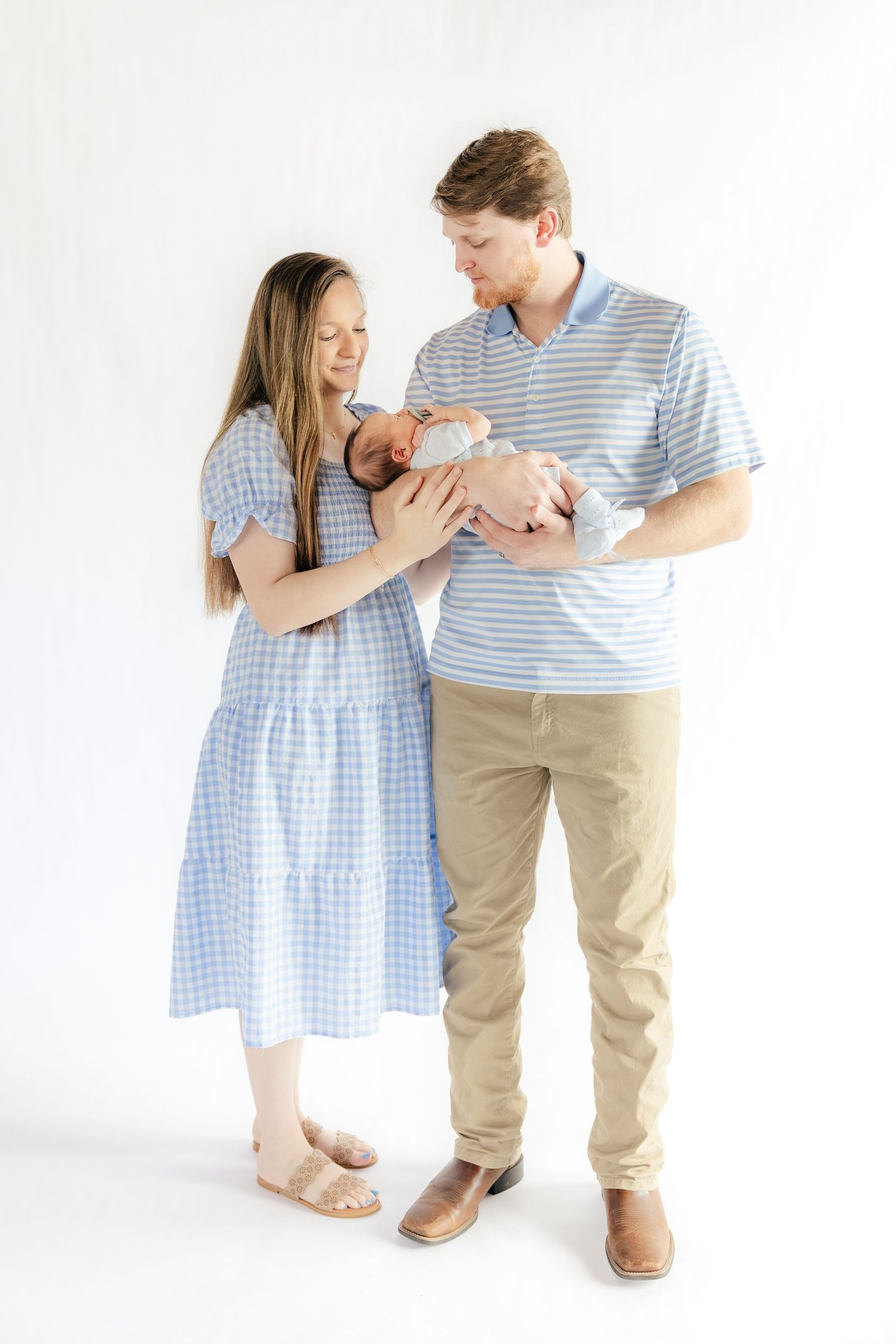 Family holding their baby in a studio in Dothan, Alabama