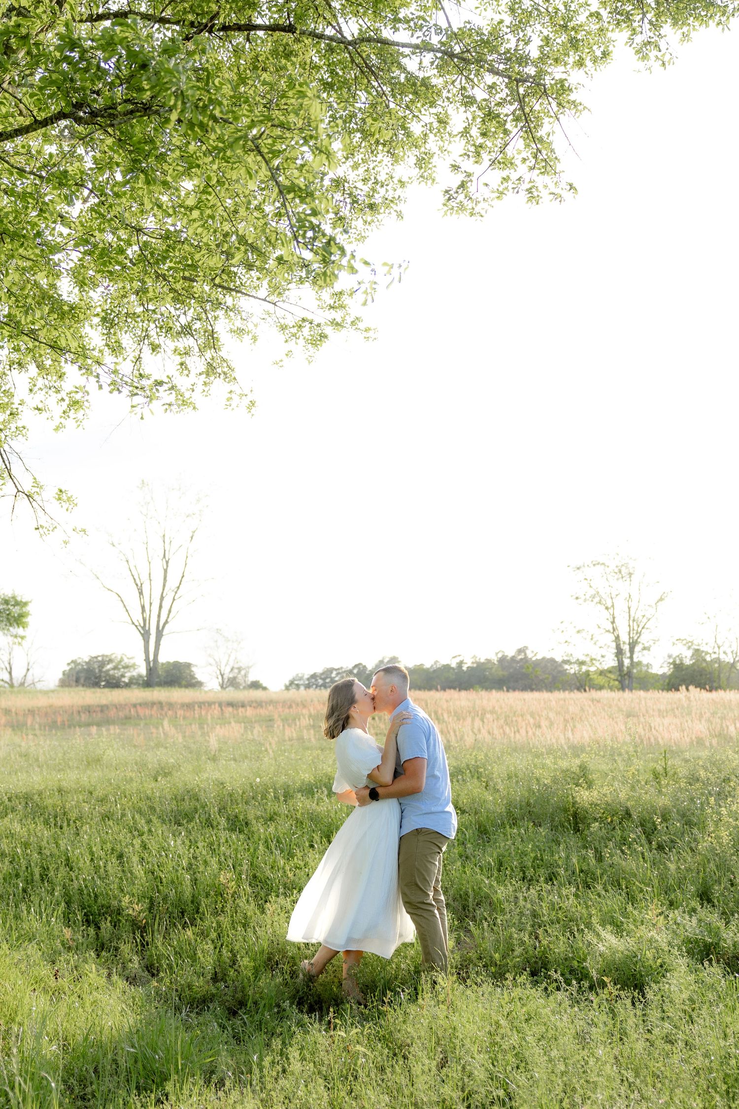 Storytelling couple photos in a tall grass field at sunset in Dothan, Alabama