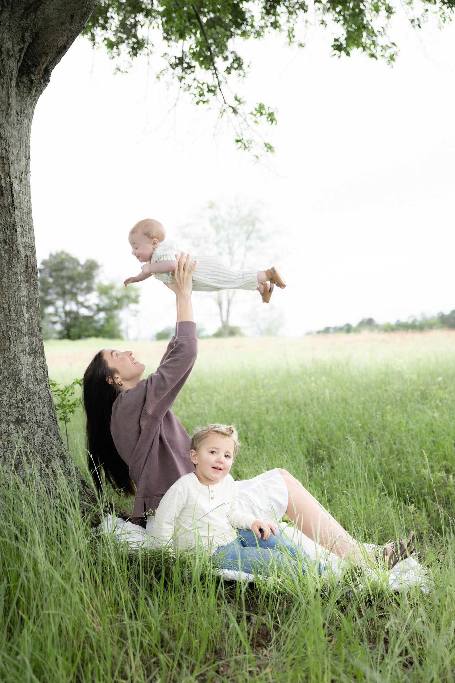 Candid family photos in a grass field | Dothan, Alabama Lifestyle Portrait Photographer