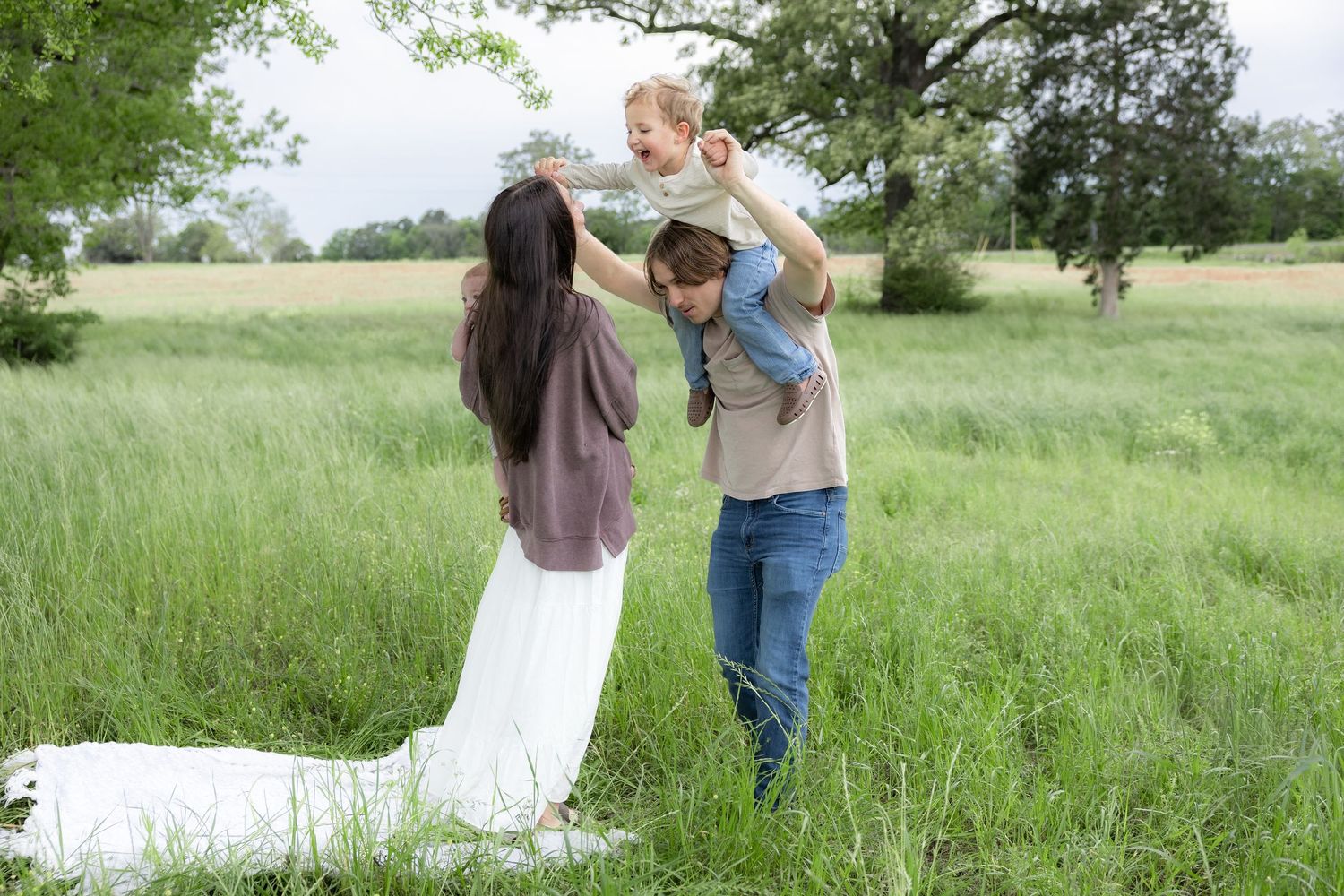 Candid family photos in a grass field | Dothan, Alabama Lifestyle Portrait Photographer