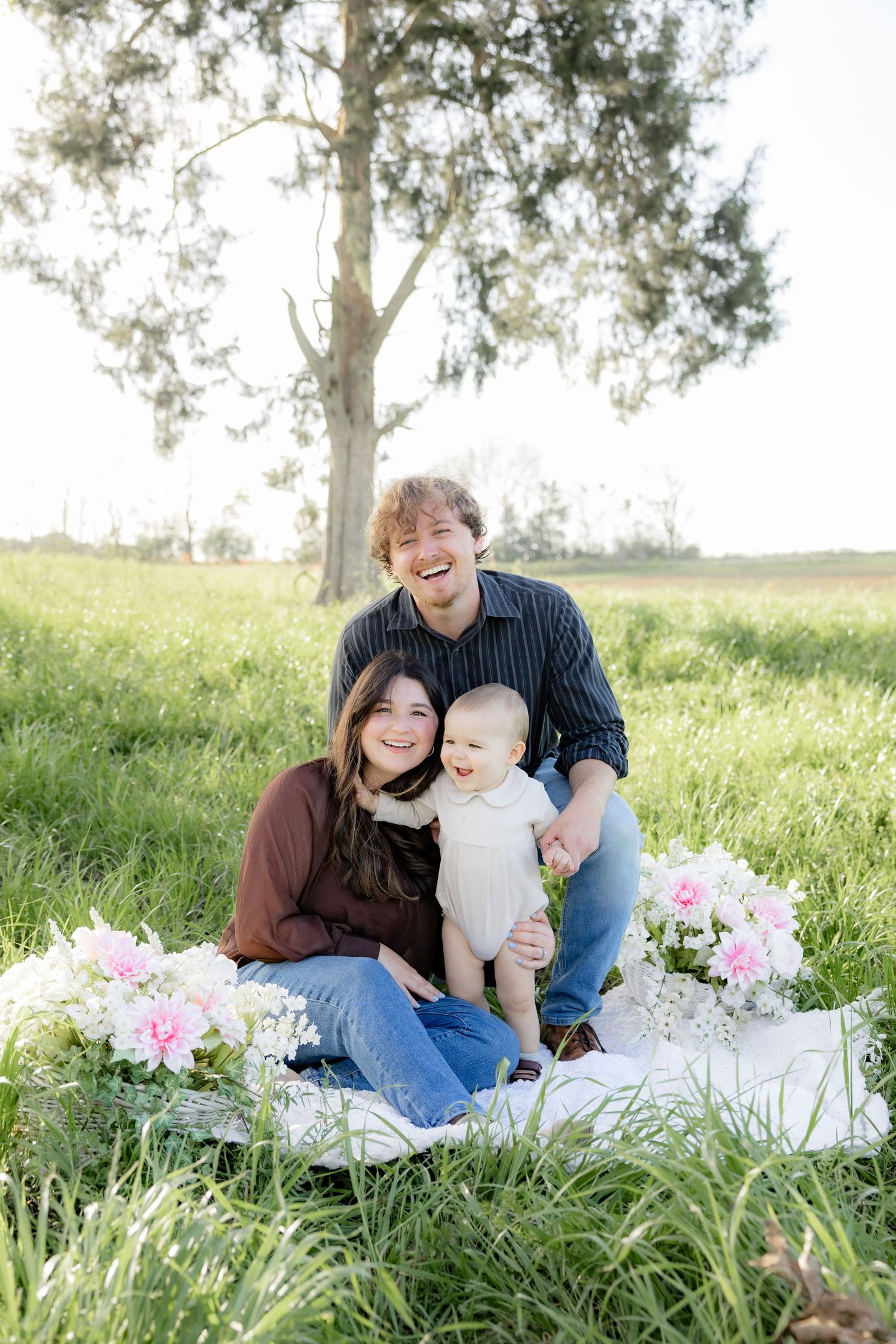 Spring Mini Session with baby chicks in a grass field at sunset near Dothan, Alabama