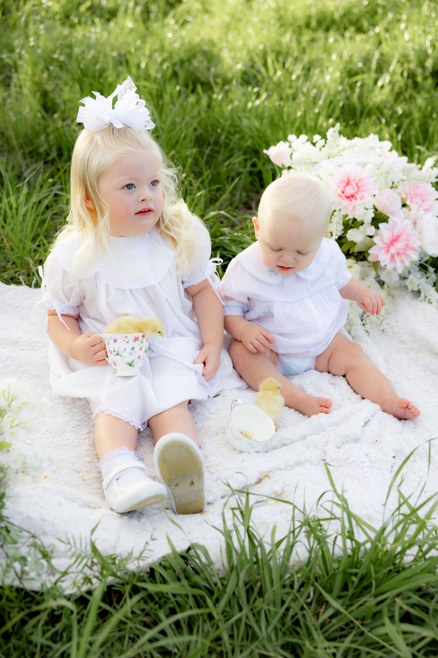 Spring Mini Session with baby chicks in a grass field at sunset near Dothan, Alabama