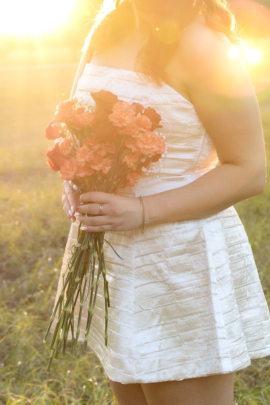Senior pictures in a field at sunset at Troy University Dothan Campus