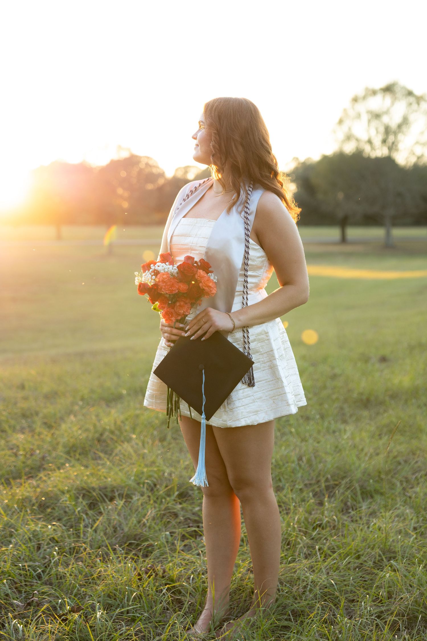 Senior pictures in a field at sunset at Troy University Dothan Campus