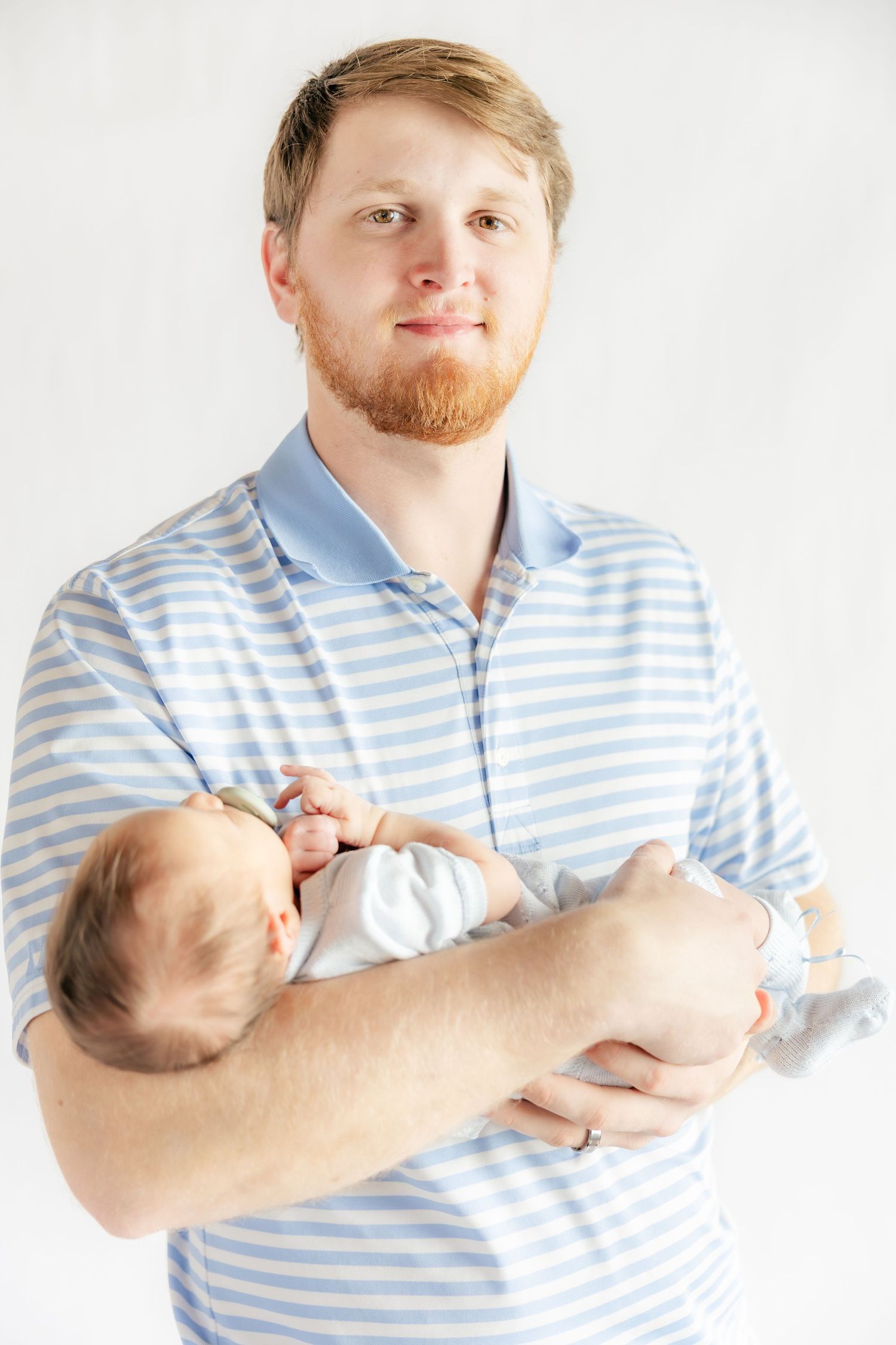 Father holding his baby in a studio in Dothan, Alabama