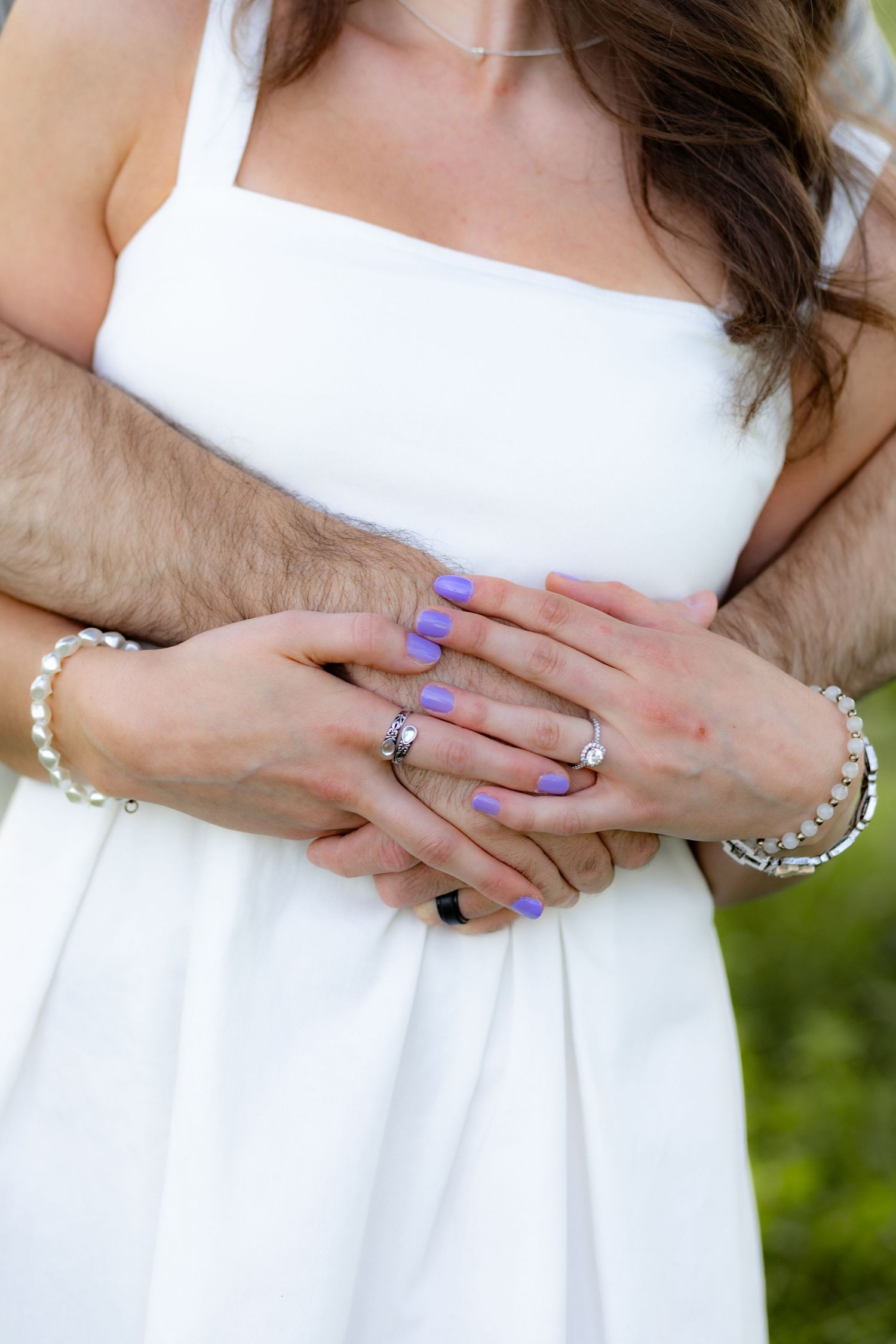 Couple holding each other in a grass field at sunset in Dothan, Alabama