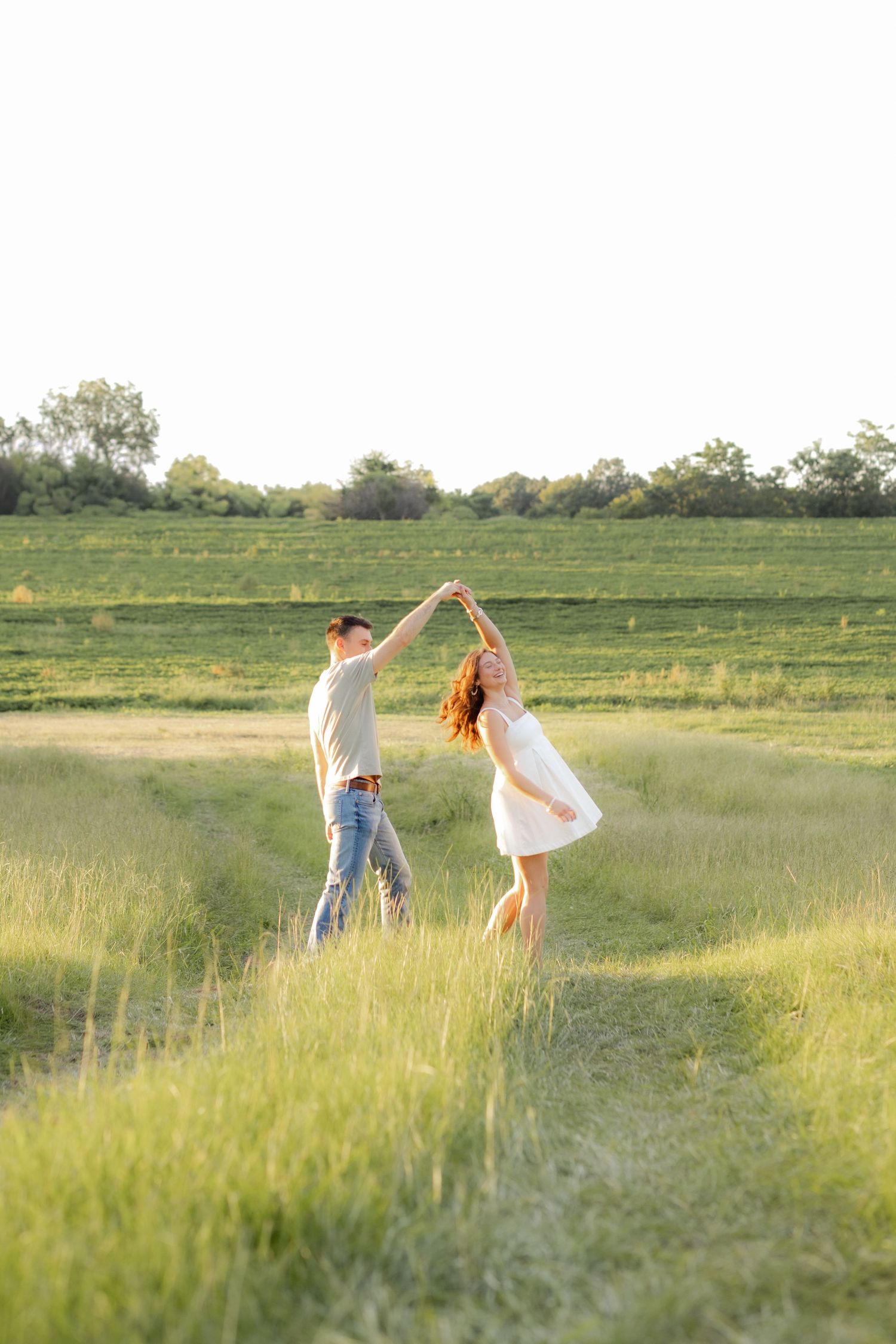 Couple dancing in a grass field at sunset in Dothan, Alabama