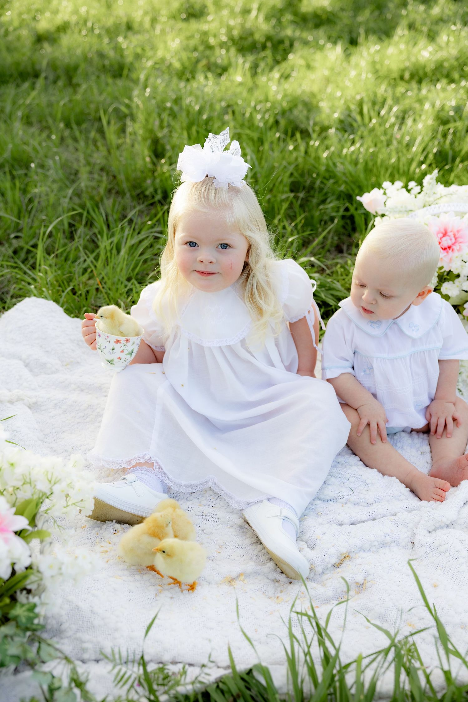Spring Mini Session with baby chicks in a grass field at sunset near Dothan, Alabama