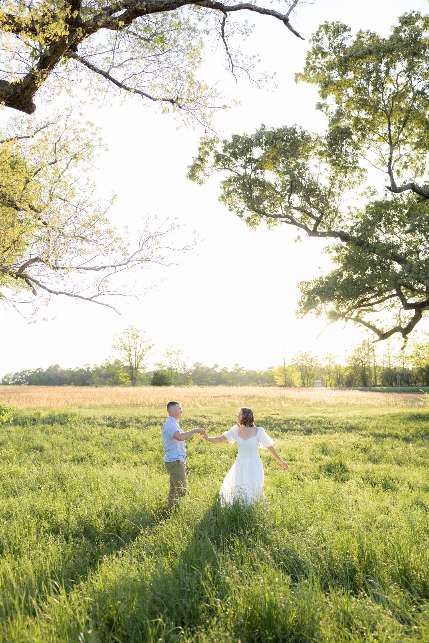 Storytelling couple photos in a tall grass field at sunset in Dothan, Alabama