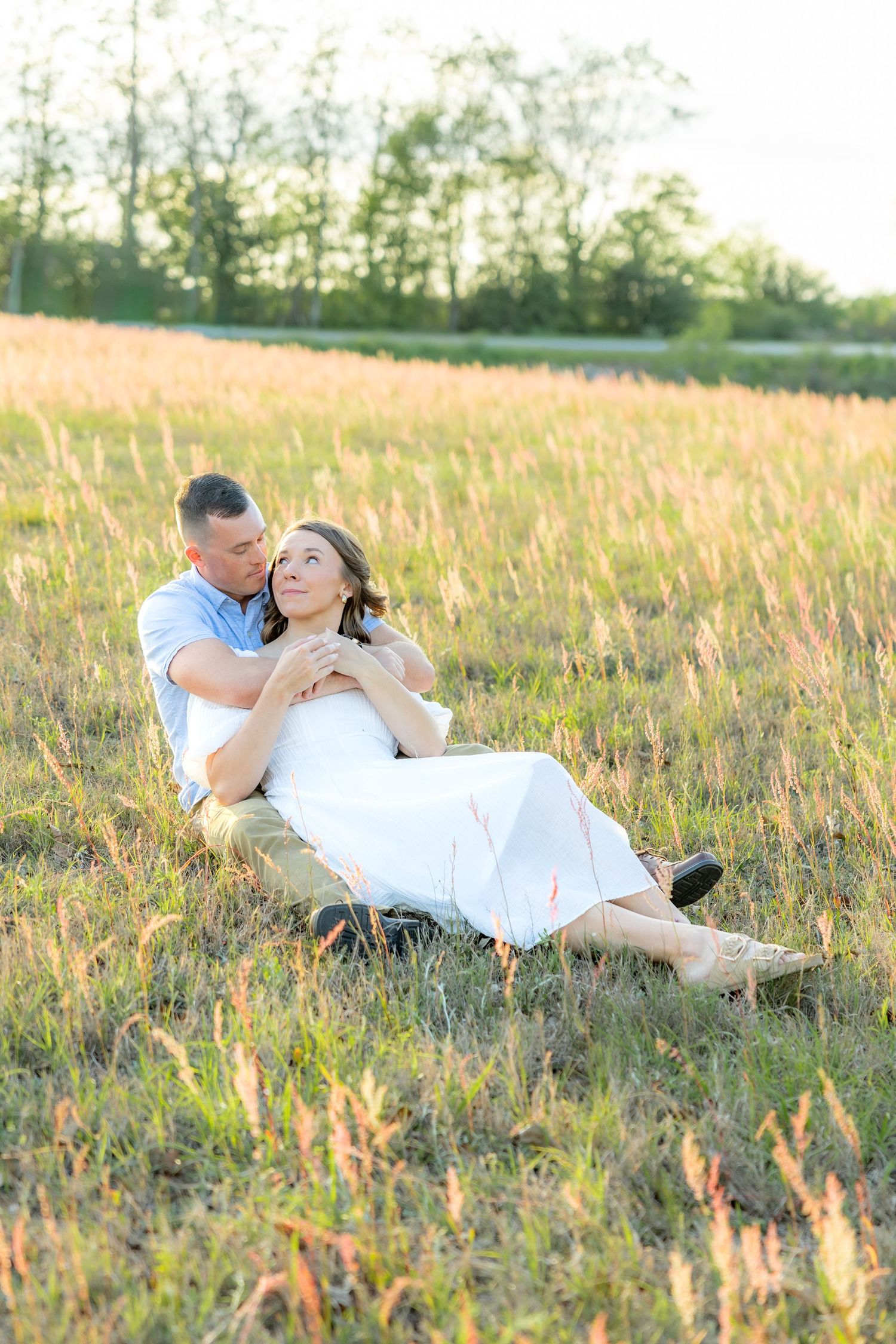 Storytelling couple photos in a tall grass field at sunset in Dothan, Alabama