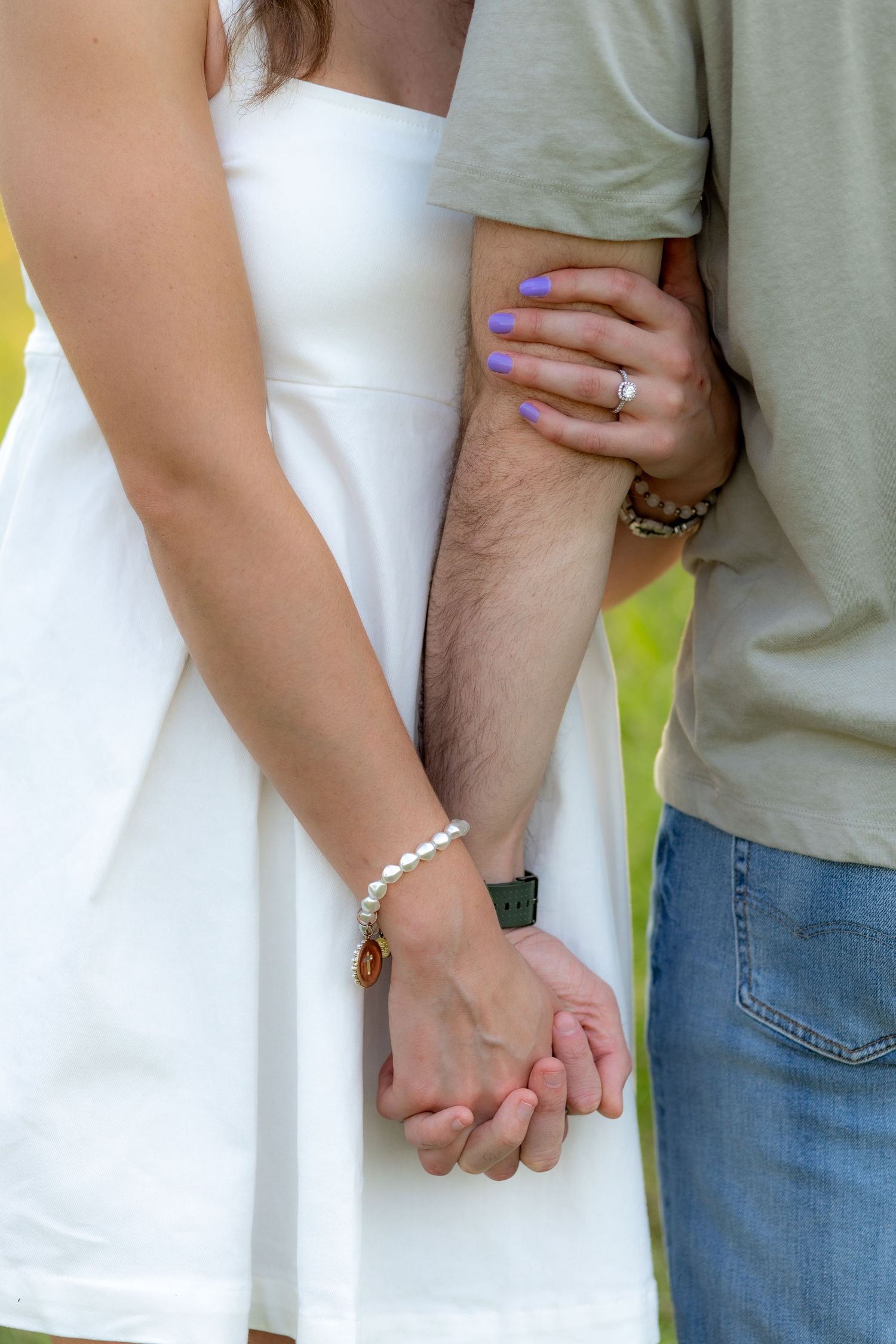 Couple holding each other in a grass field at sunset in Dothan, Alabama