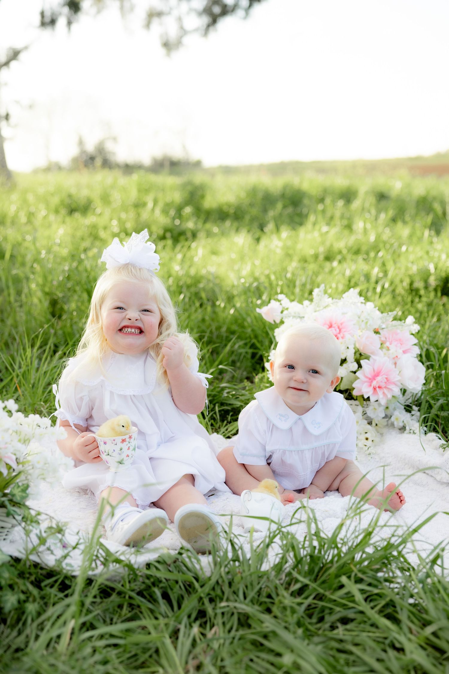 Spring Mini Session with baby chicks in a grass field at sunset near Dothan, Alabama