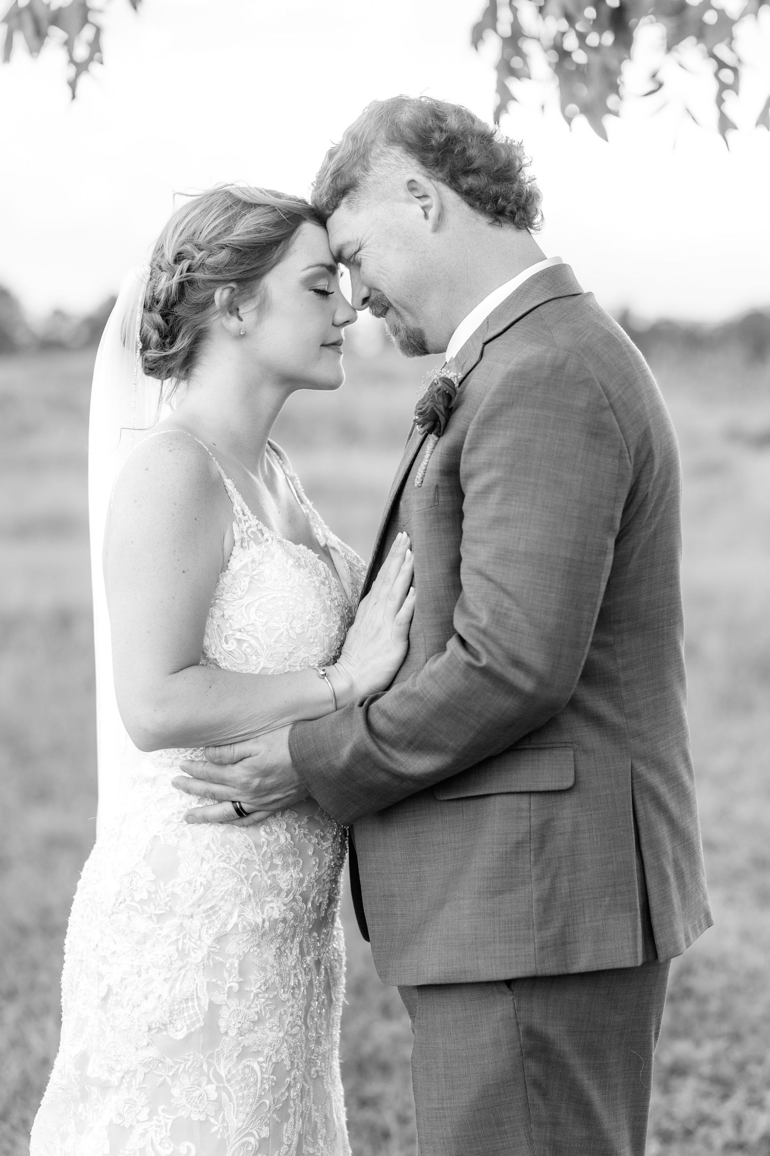 Bride and groom hold each other at sunset at Hilltop Acres Wicksburg, Alabama