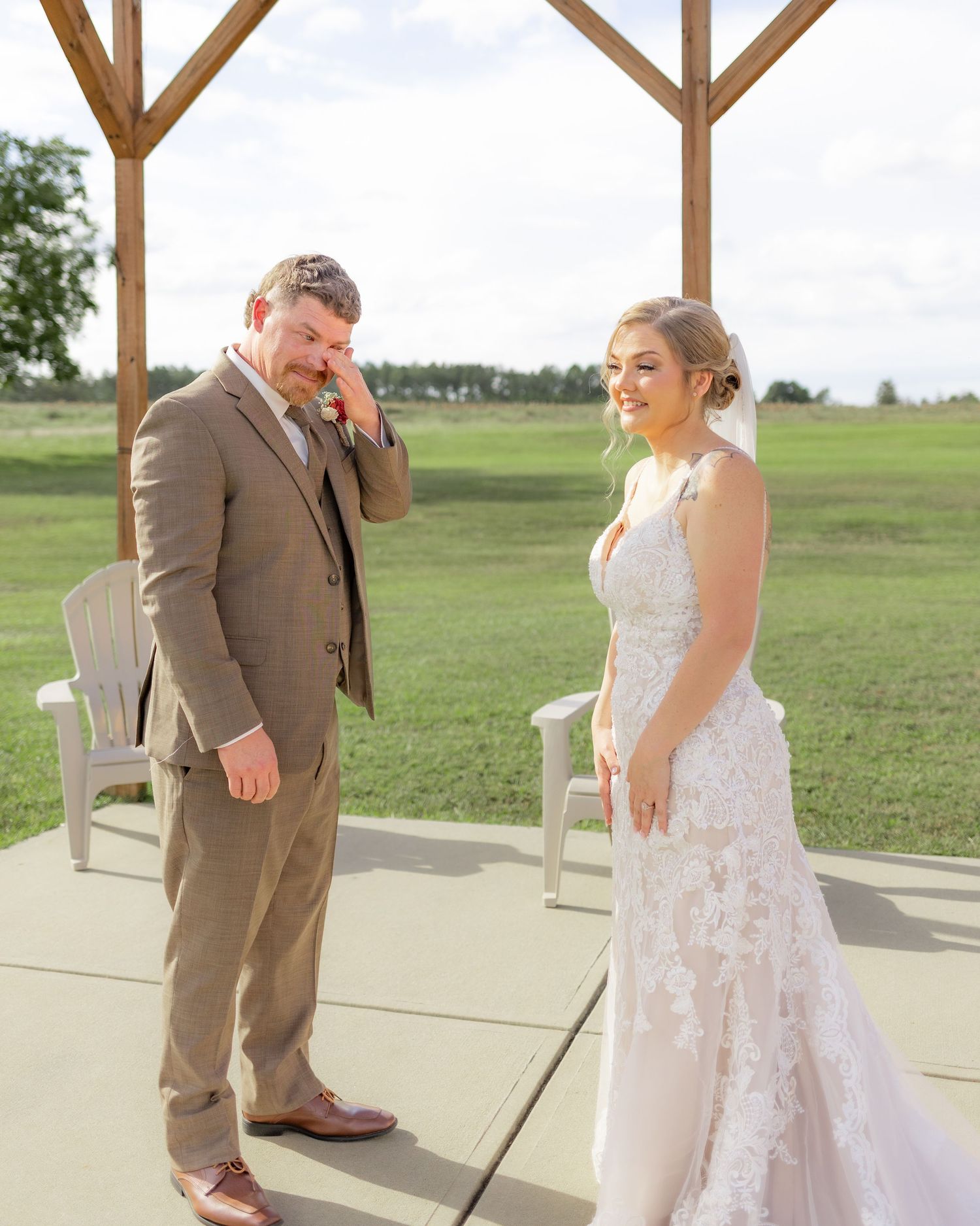 Groom first look with bride underneath the gazebo at Hilltop Acres Wicksburg, Alabama