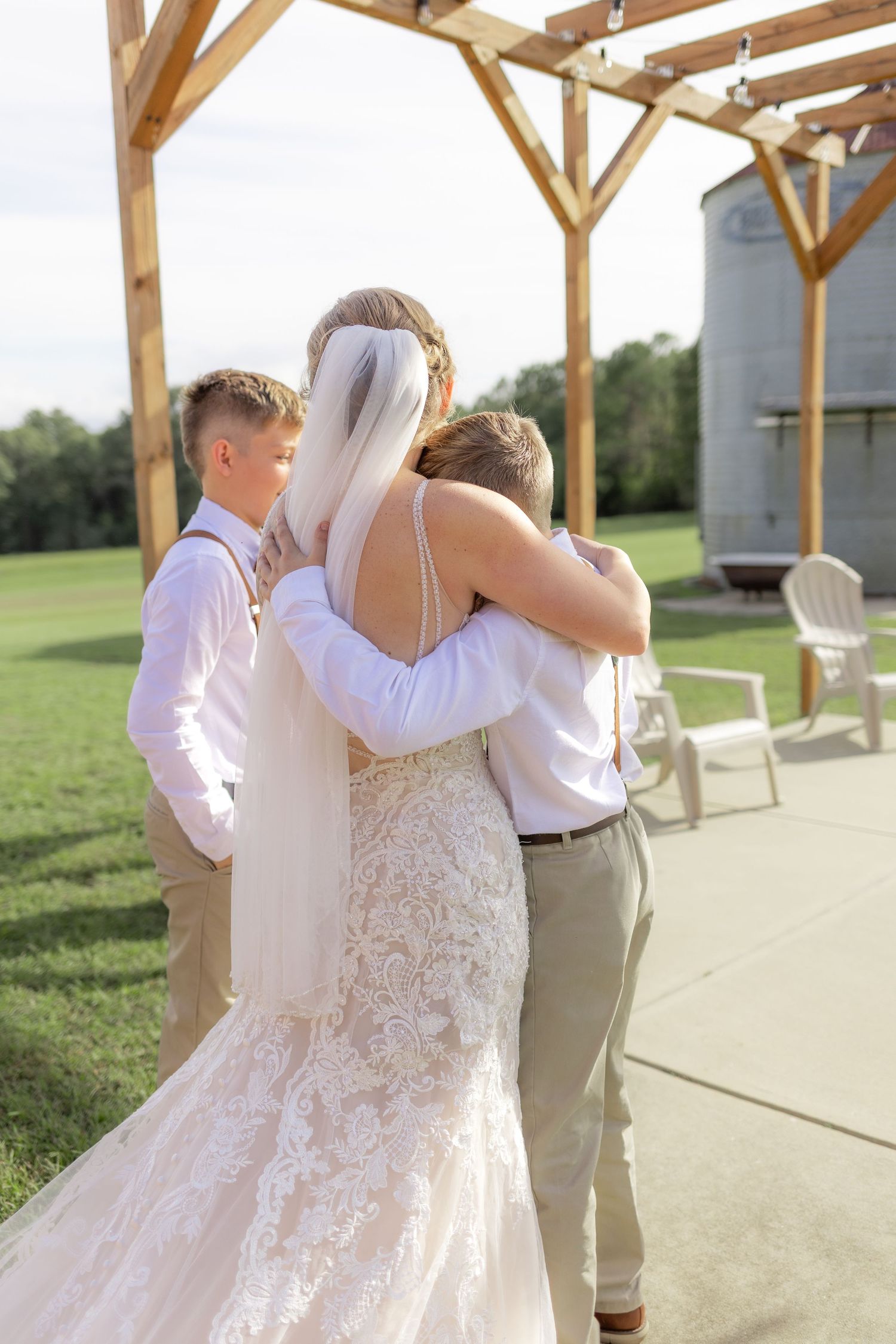 Sons' first look with bride underneath the gazebo at Hilltop Acres Wicksburg, Alabama