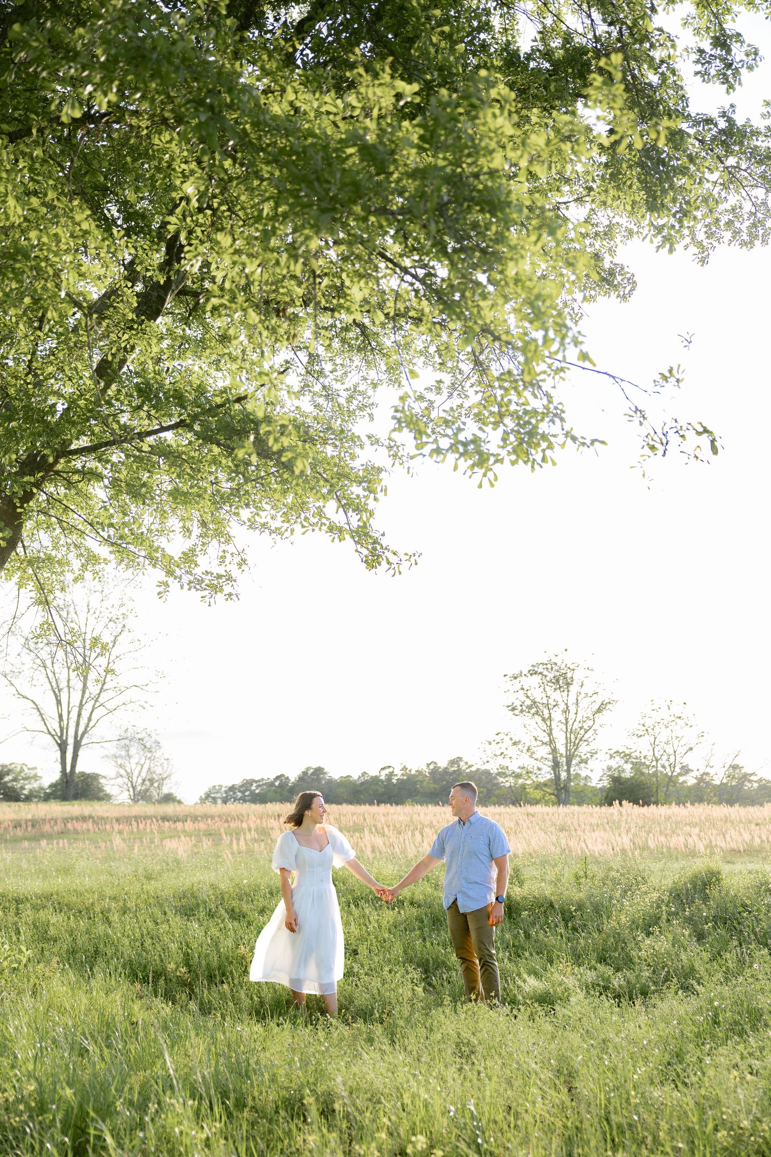 Storytelling couple photos in a tall grass field at sunset in Dothan, Alabama
