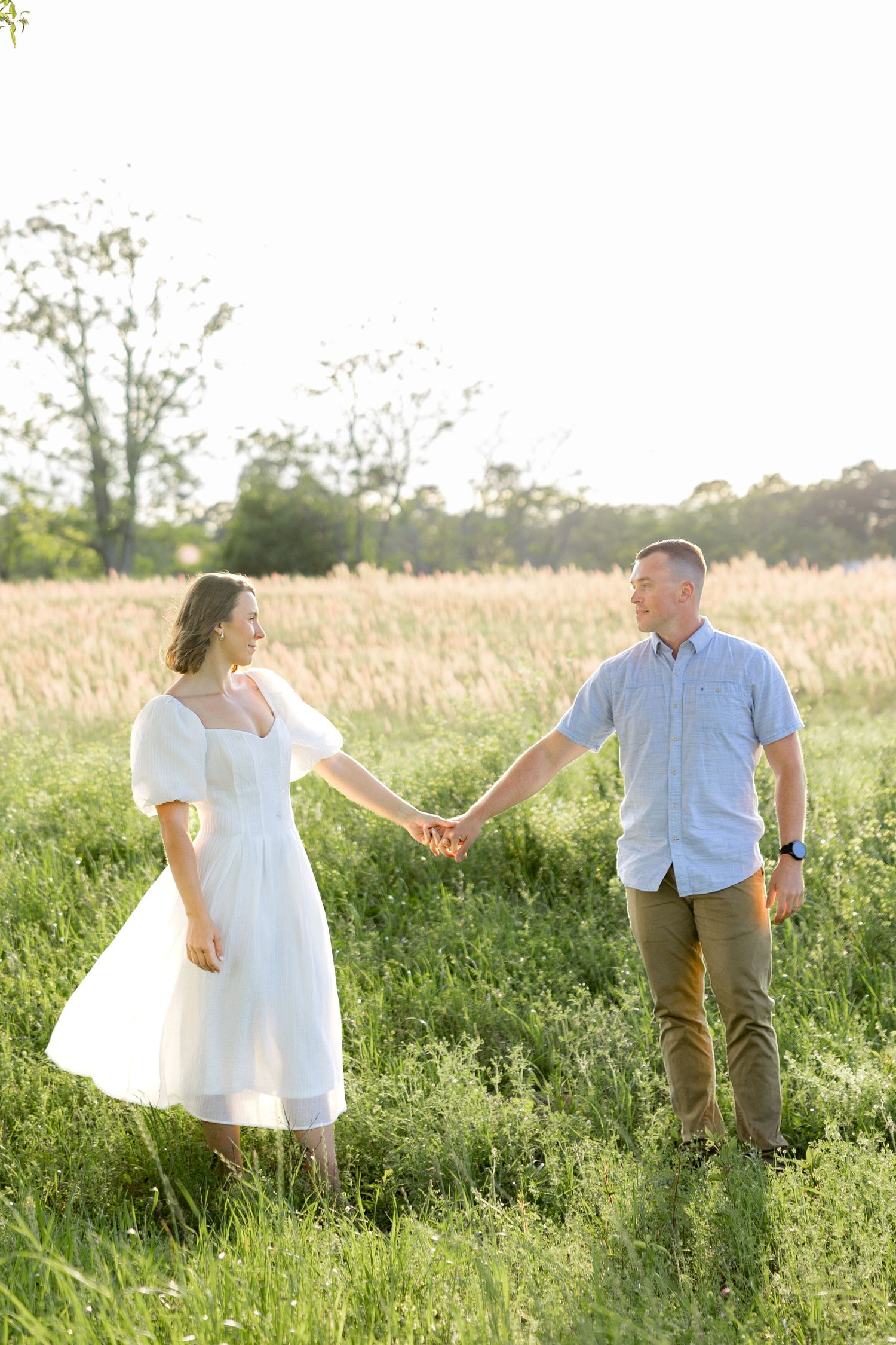 Storytelling couple photos in a tall grass field at sunset in Dothan, Alabama