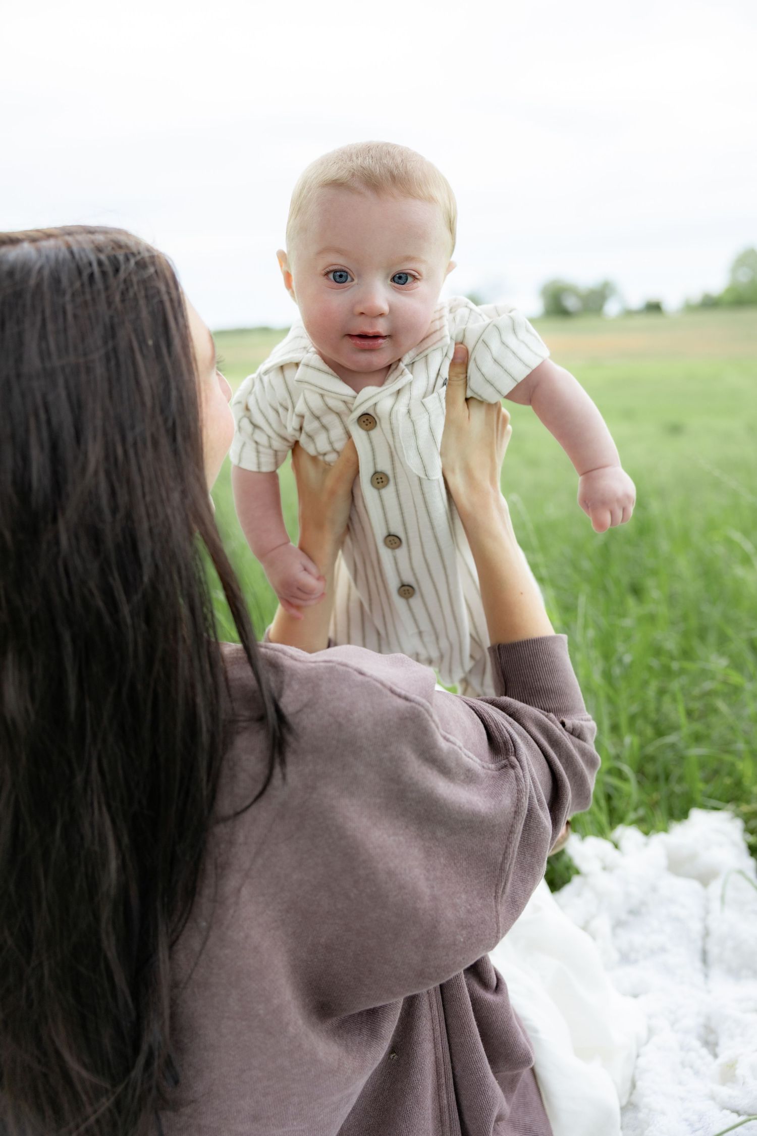 Candid family photos in a grass field | Dothan, Alabama Lifestyle Portrait Photographer