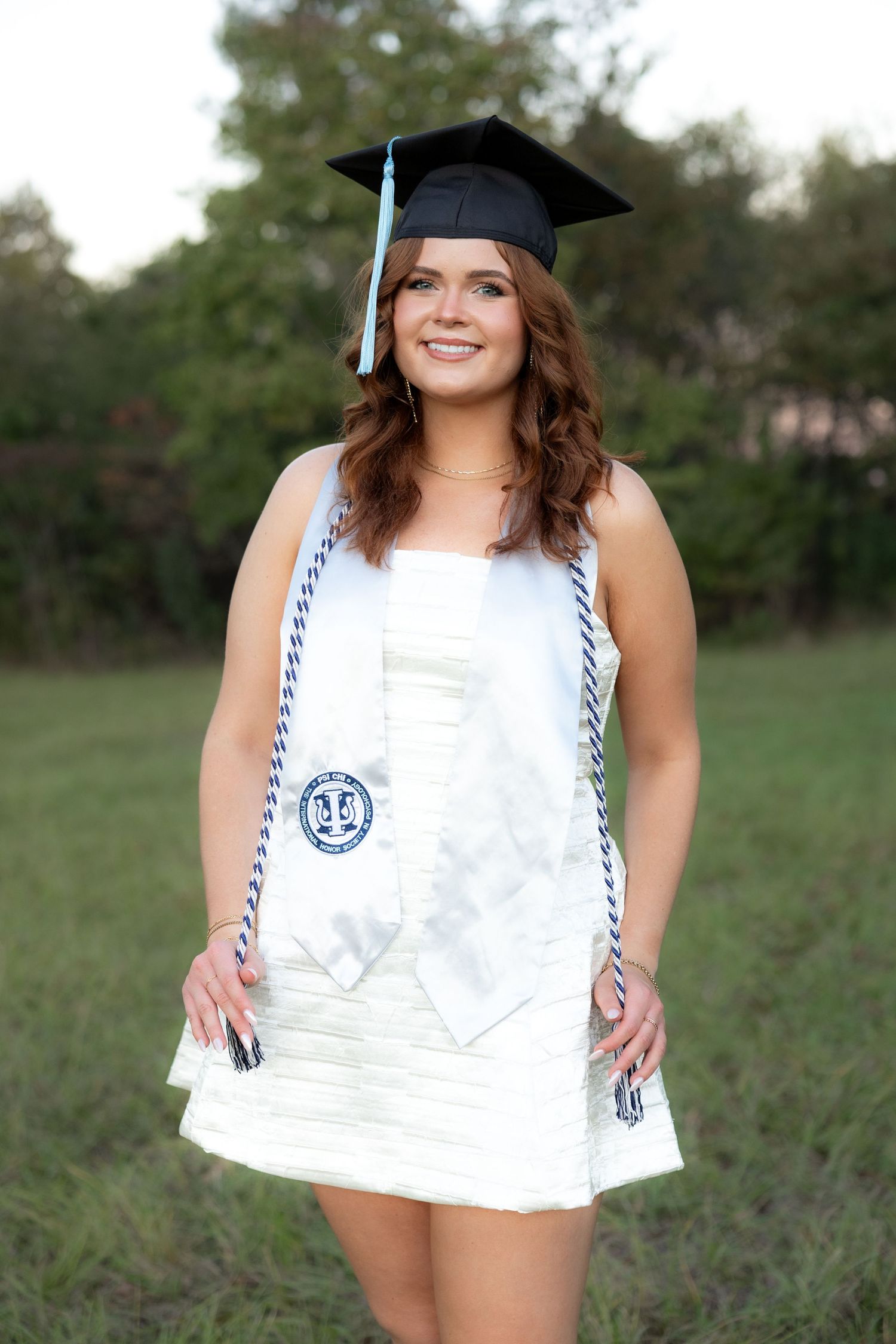 Senior pictures at sunset in a field at Troy University Dothan Campus