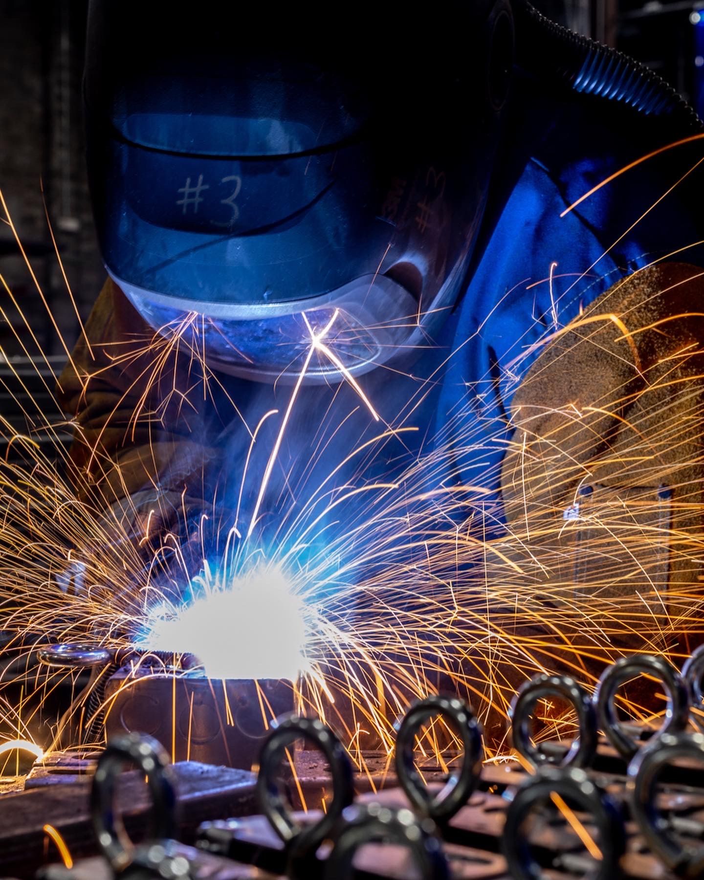 Bright orange sparks fly during welding.