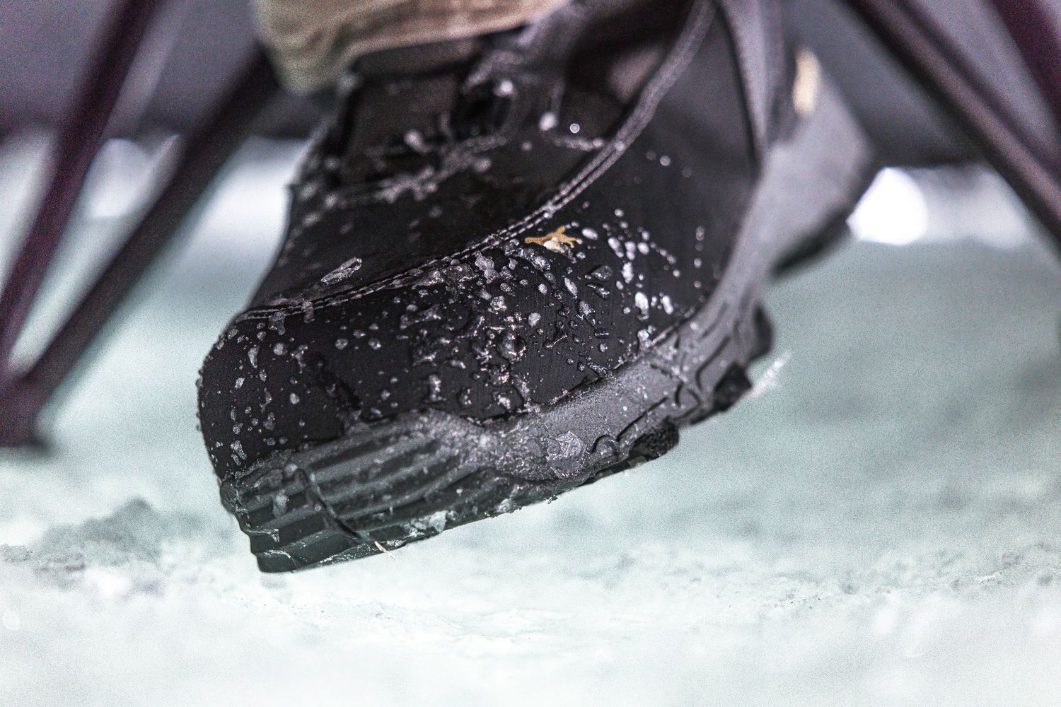 Boots walking on snowy ice surface in sequence.