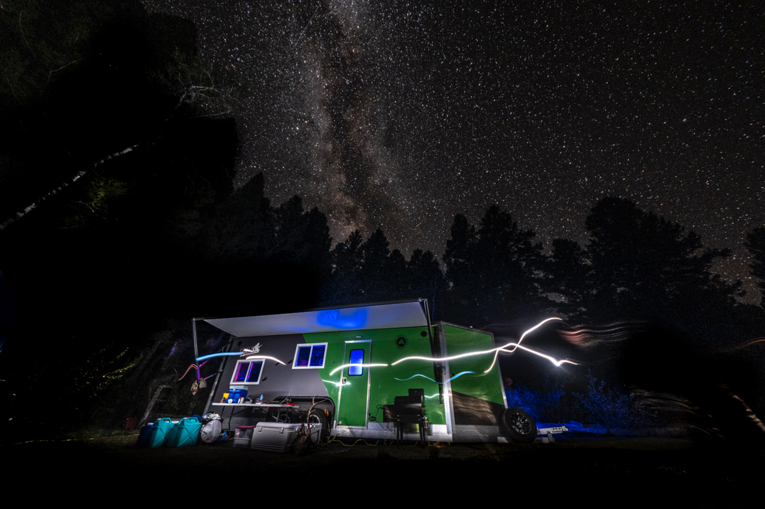Nighttime landscape with illuminated buildings and dark starry sky.