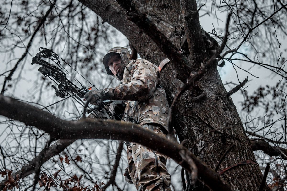 Hunter perched in a tree stand during winter hunting season.
