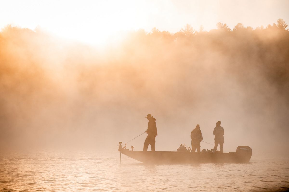 Silhouettes of fishermen at sunrise.