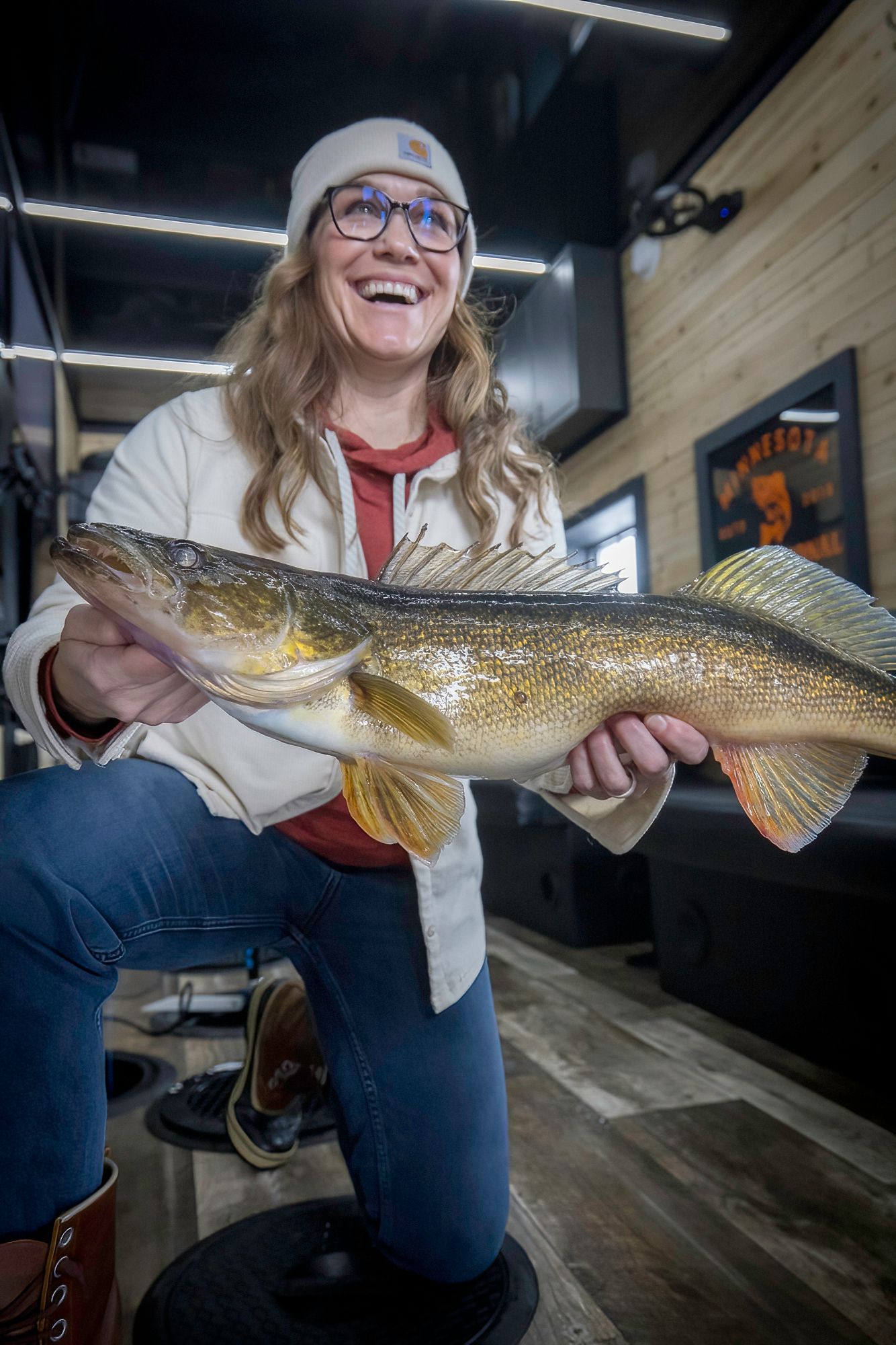 Large walleye fish being displayed.