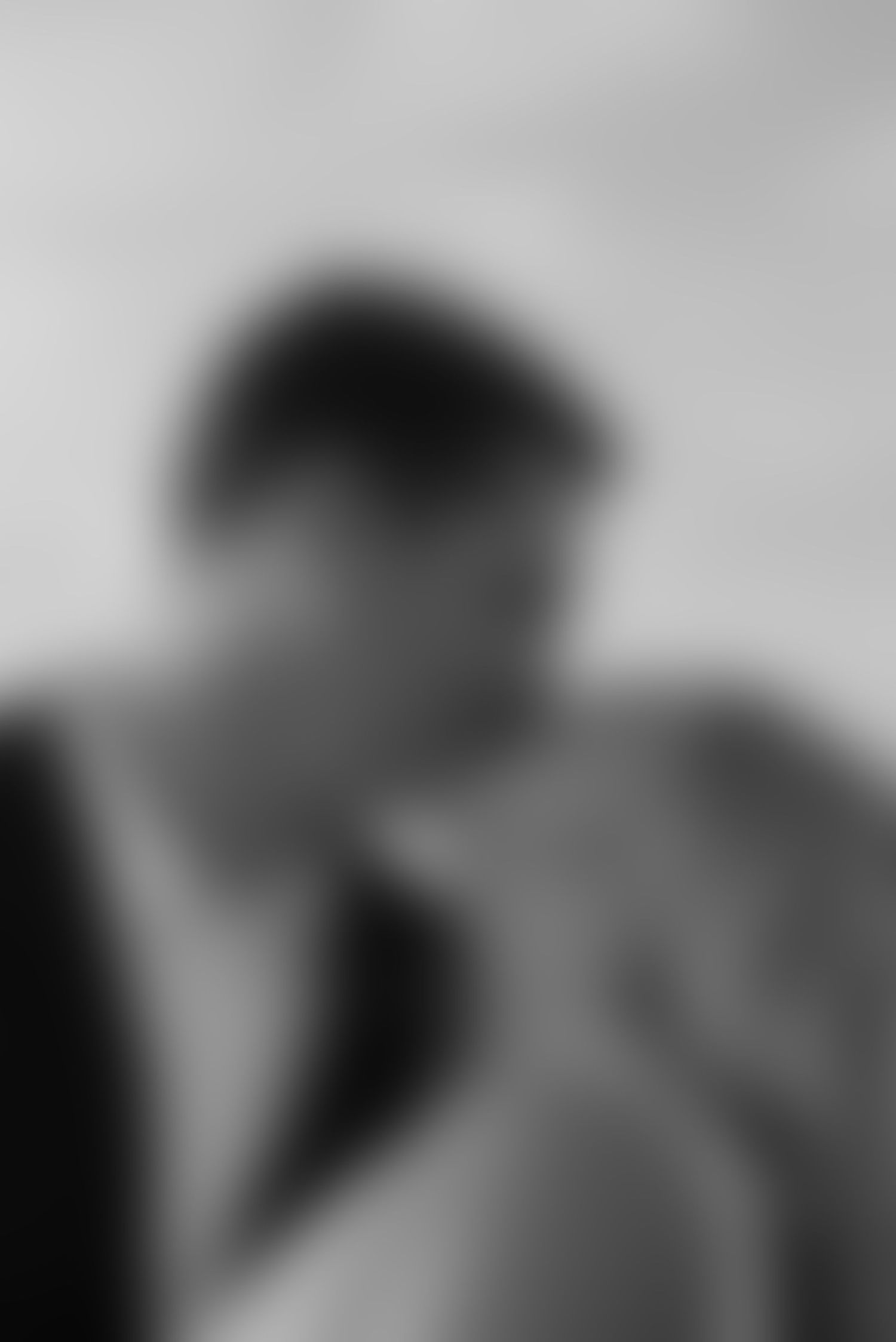 Black and white close-up portrait of couple sharing an intimate romantic moment together.