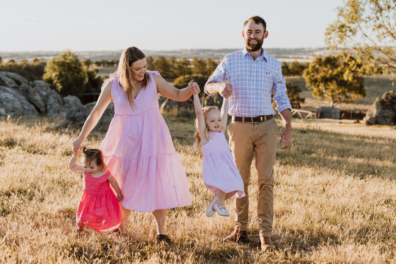 Golden sunset family photography session on a rural farm in Young, NSW, featuring parents and children
