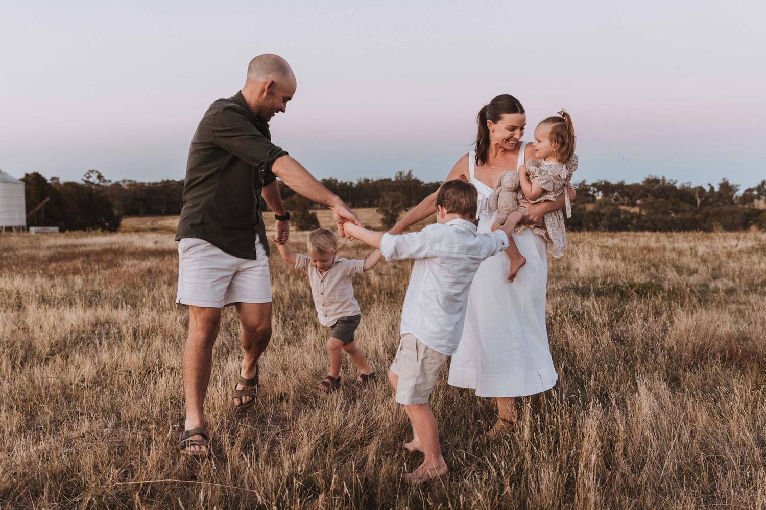 Golden sunset family photography session on a rural farm in Young, NSW, featuring parents and children