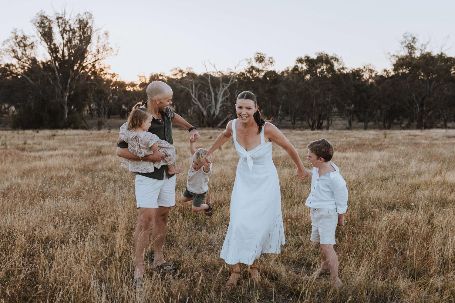 Candid fun family photography on a farm at sunset in Young NSW