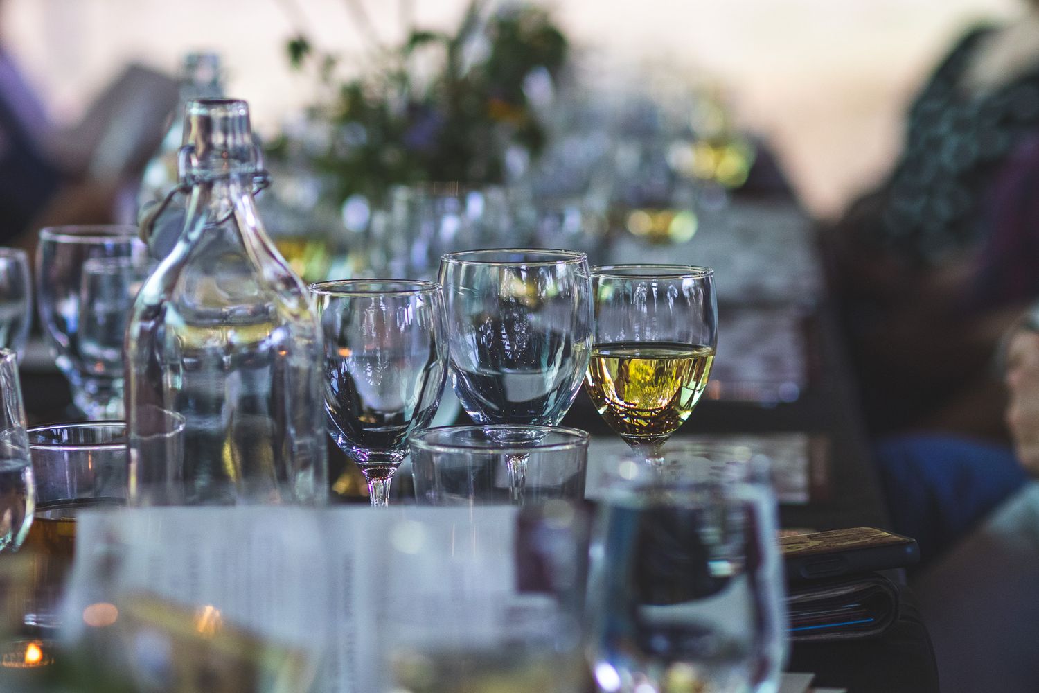 Elegant table setting with crystal glassware and wine glasses arranged for a formal dinner event.