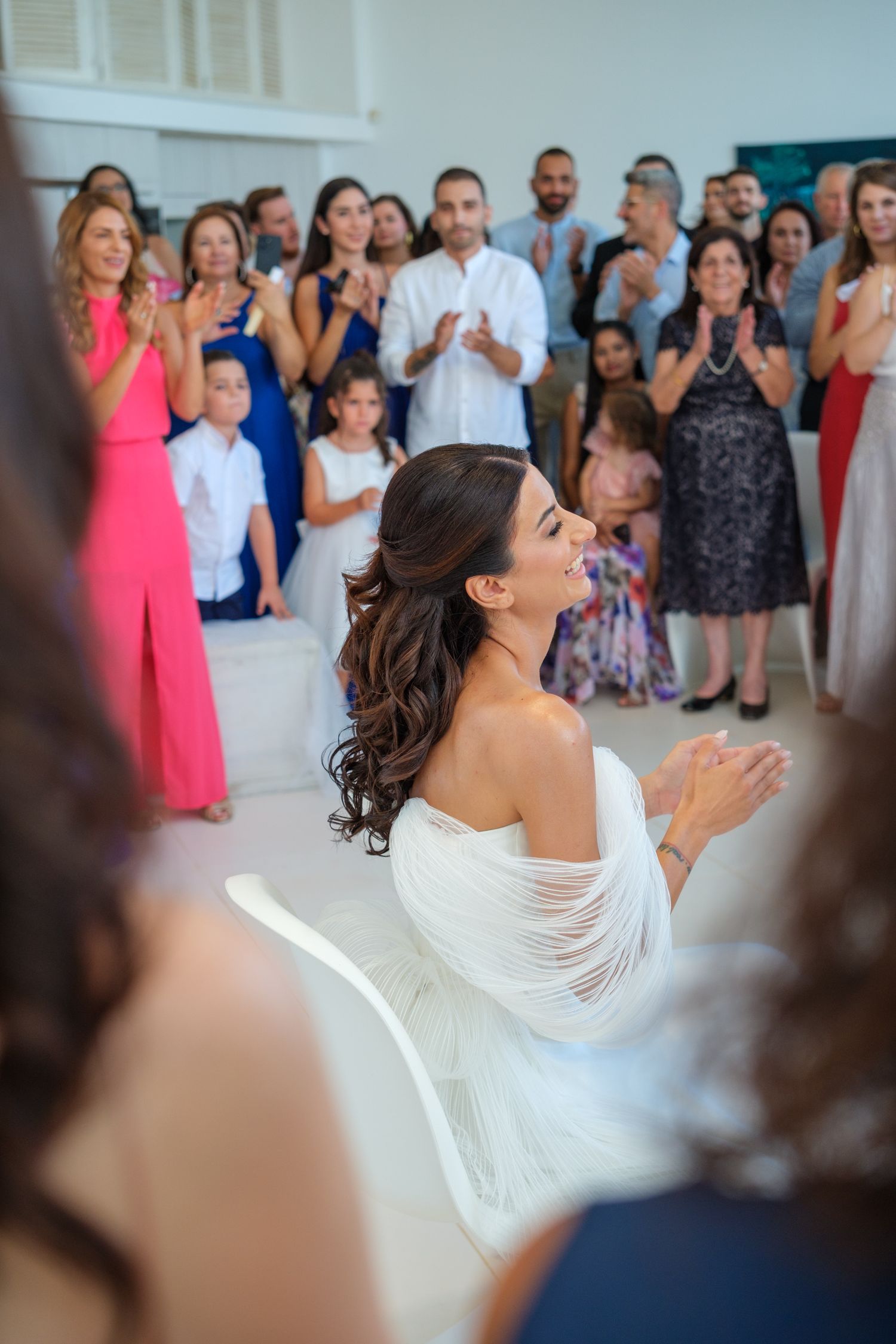 Wedding celebration scene with guests applauding in background.