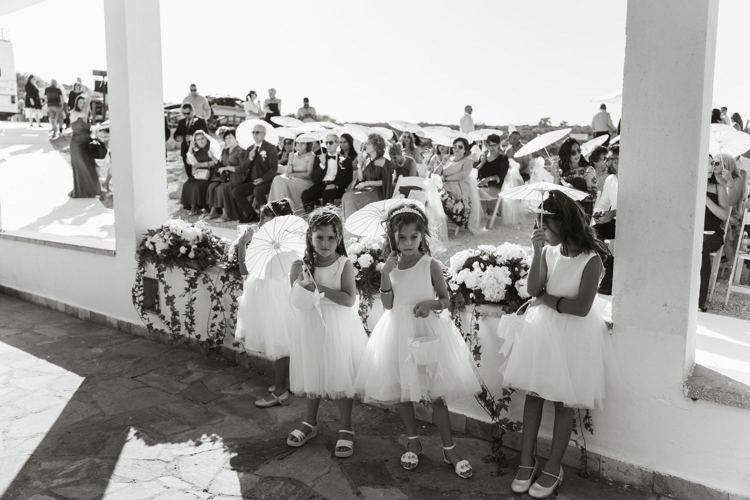 A collection of black and white wedding photos arranged in a collage showing ceremony and reception moments.