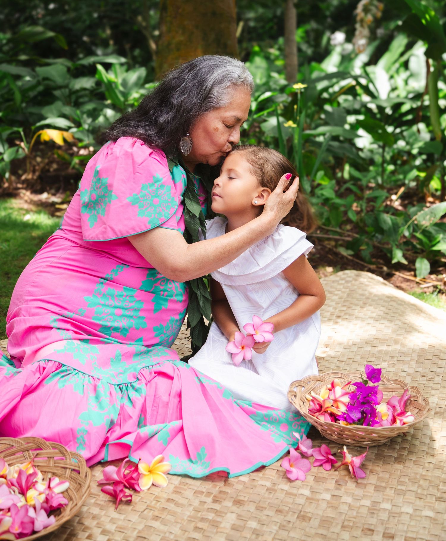 Mother and child with flower lei during Oahu Hawaii motherhood photography