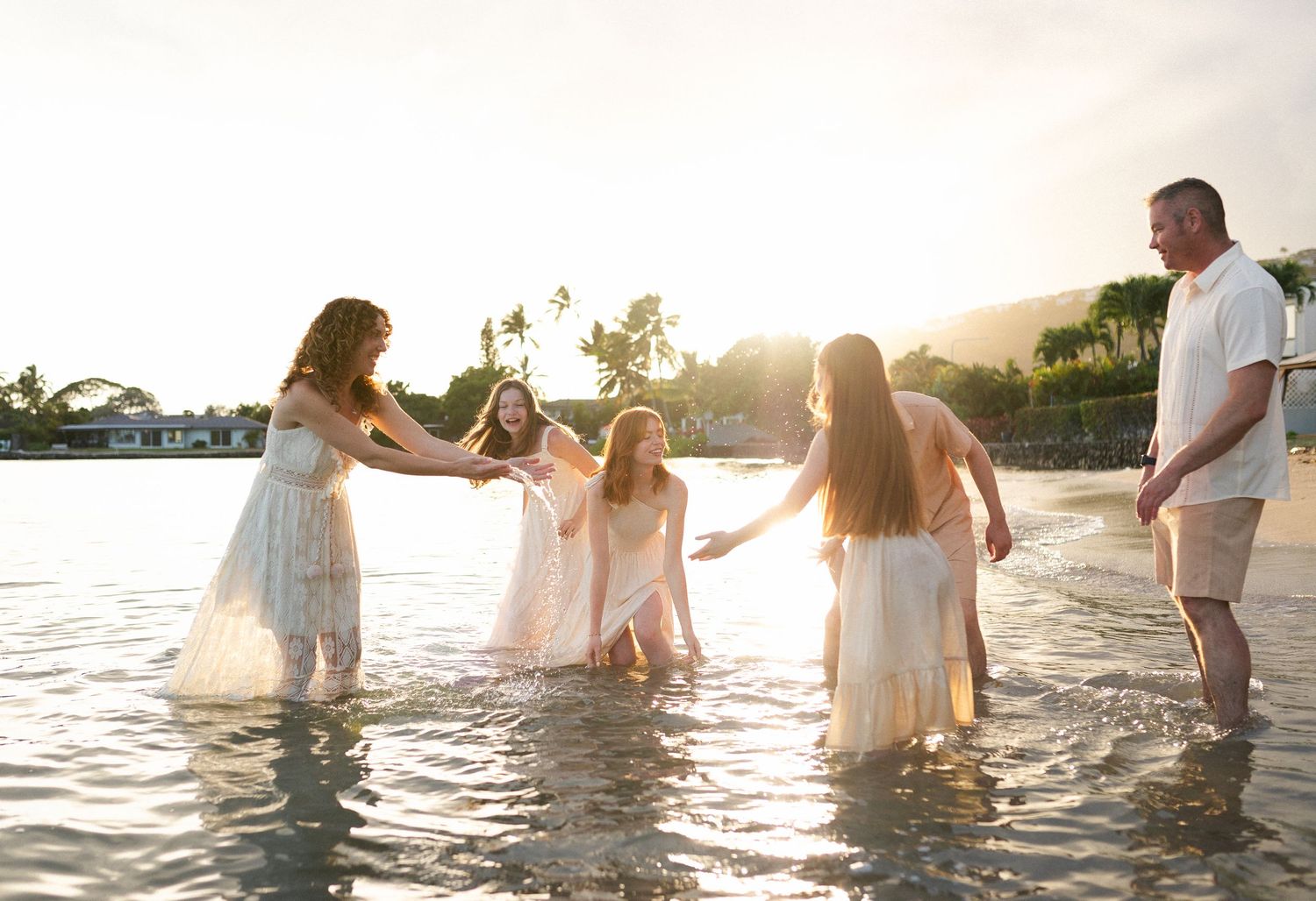 Family photography session at the beach with a sunset in Hawaii