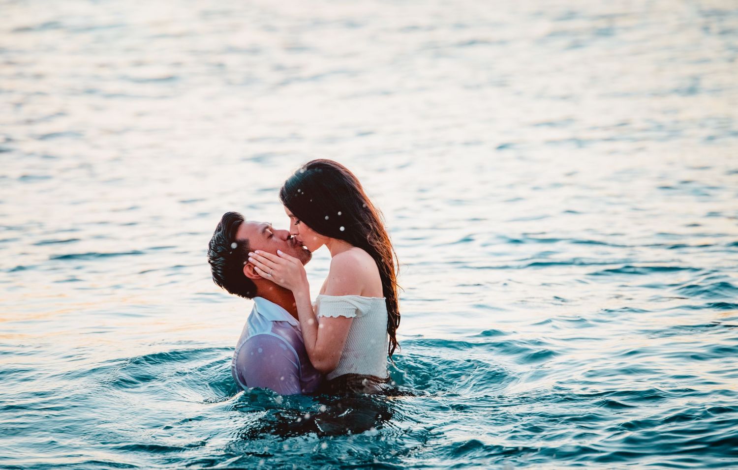 Engagement photography with a couple in the ocean in Hawaii