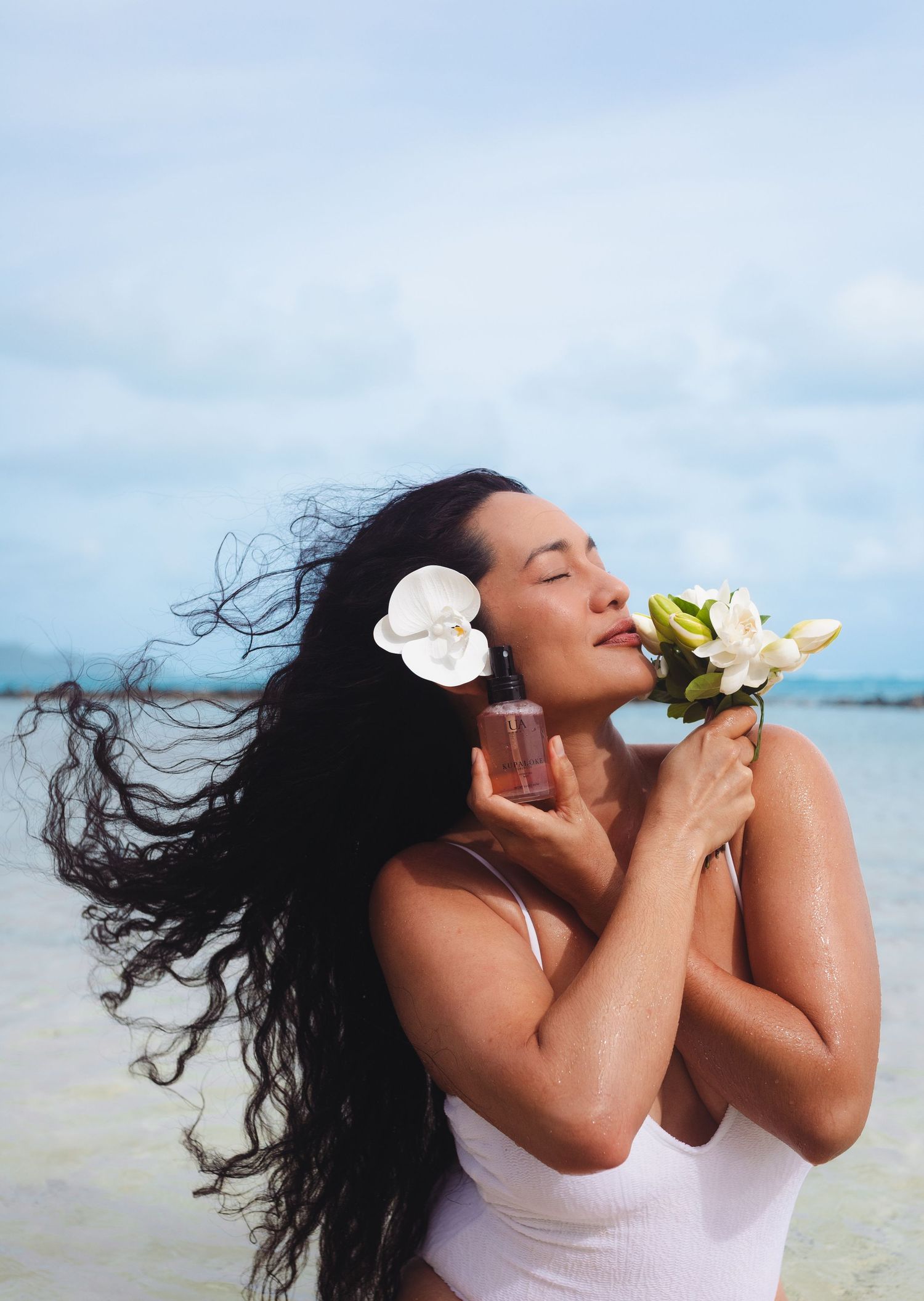 Hawaii product photography in water with tropical flowers