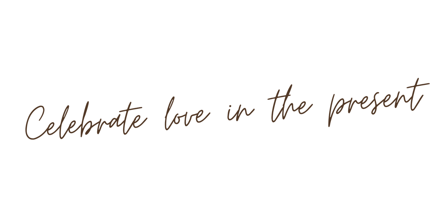 Elegant cursive script reading Celebrate love in the present on a white background.