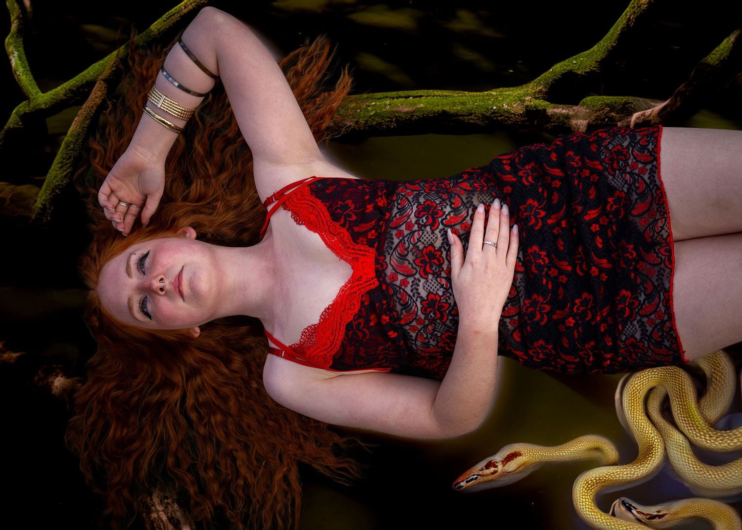 Dramatic portrait series with red dress against textured backdrop and flowing fabric.
