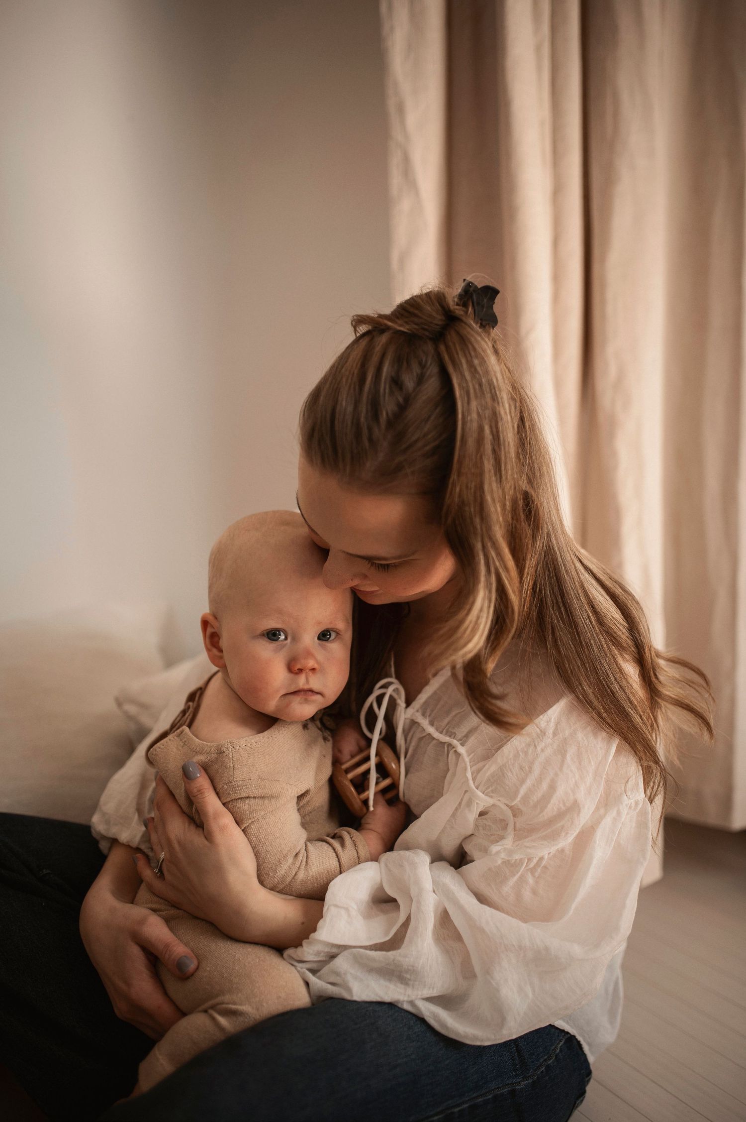 Förälder och bebis delar en glad stund under en familjefotografering i Hässleholm.