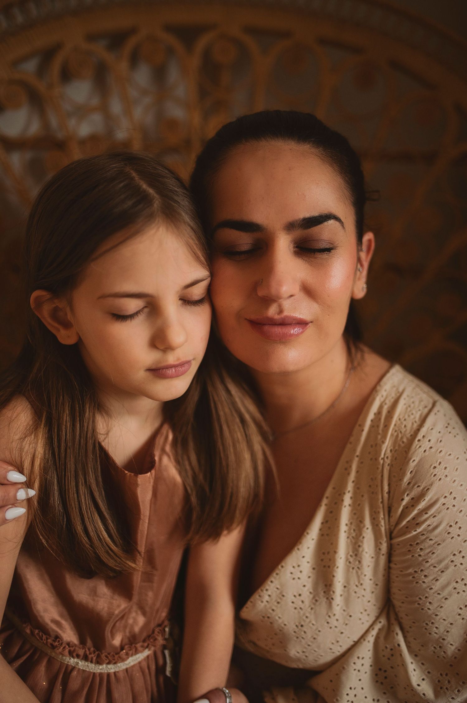 A tender embrace captured against an ornate backdrop in warm, moody lighting.