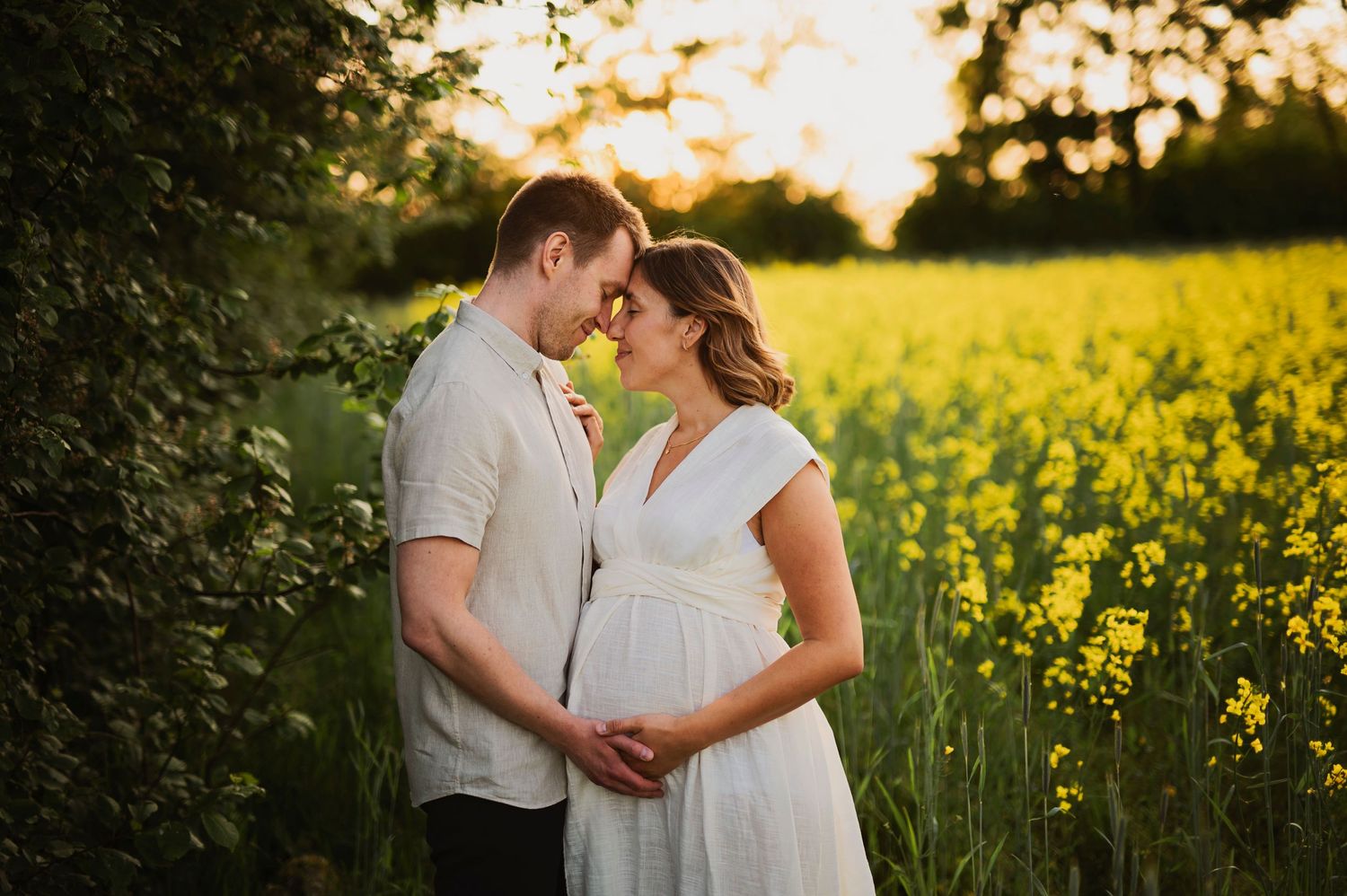 A romantic sunset portrait in a blooming yellow canola field.