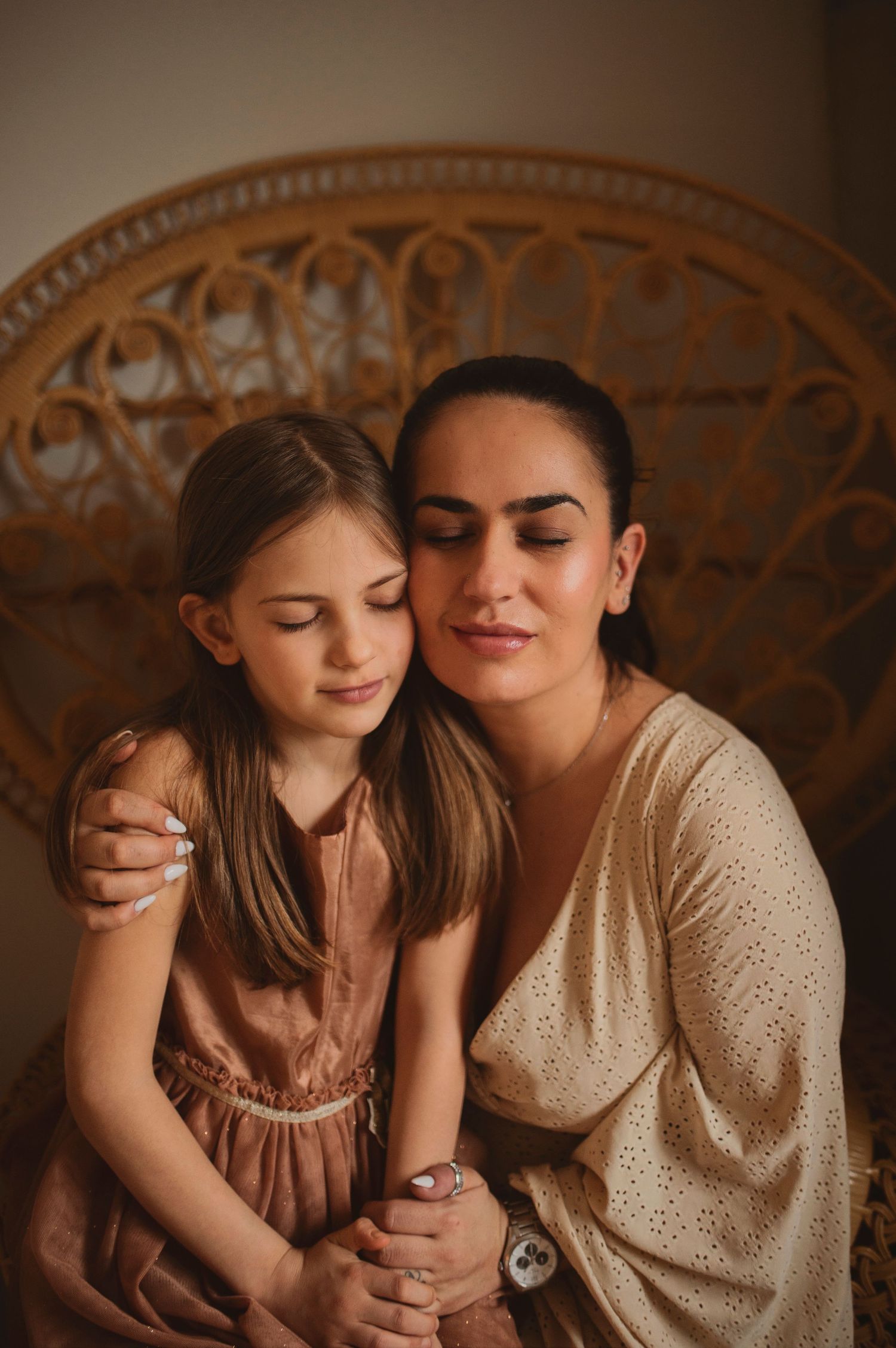 Peaceful portrait featuring soft lighting and natural connection against woven chair.